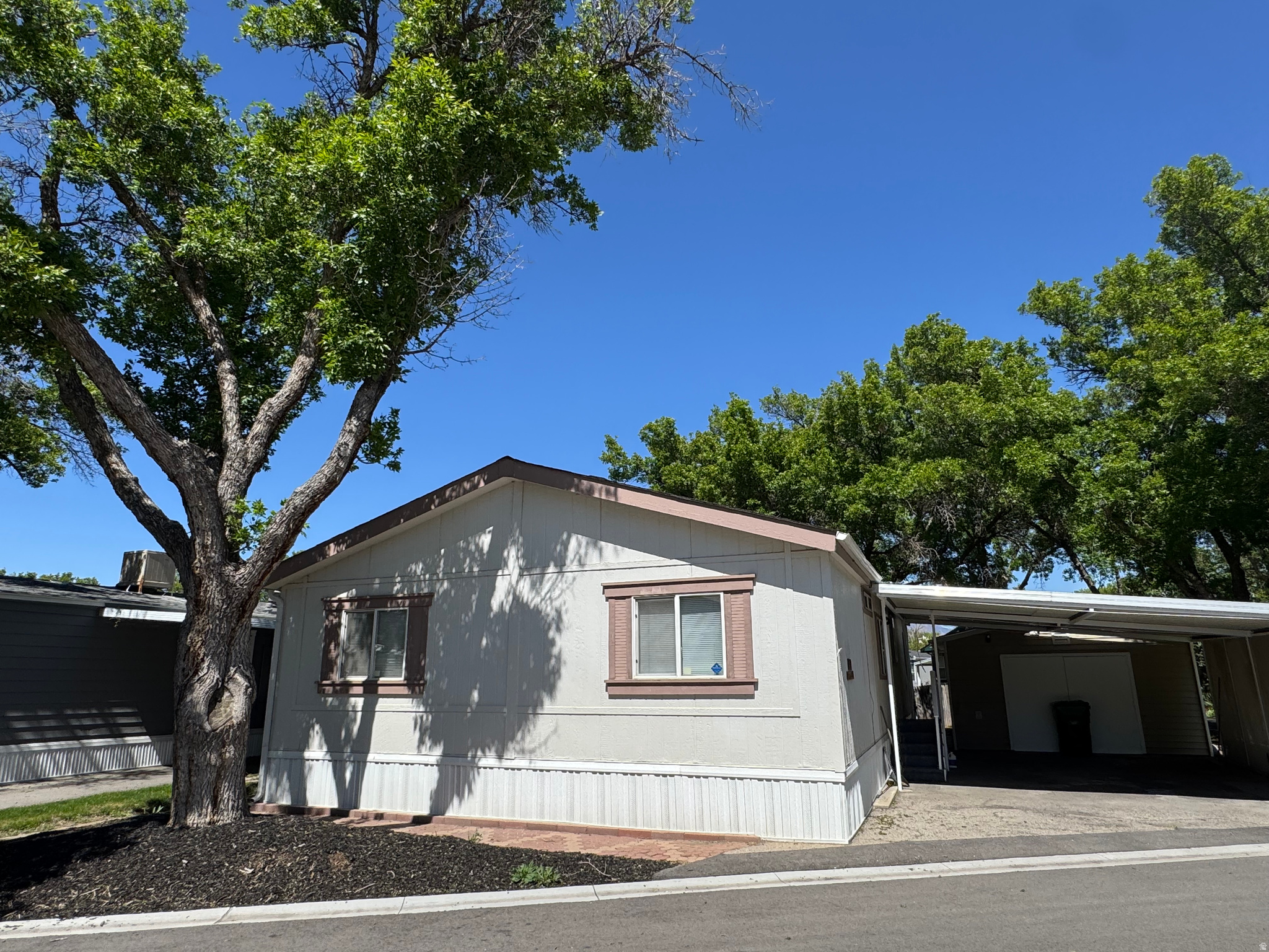 55 + Community, Updated, new paint, brand new roof, with the only garage /  and 220 V workshop in the park.  3 bedroom 2 bath on corner lot with full landscaping. Updated kitchen  One of a kind  with 2nd shed makes this live large! Monthly lot rent $1028