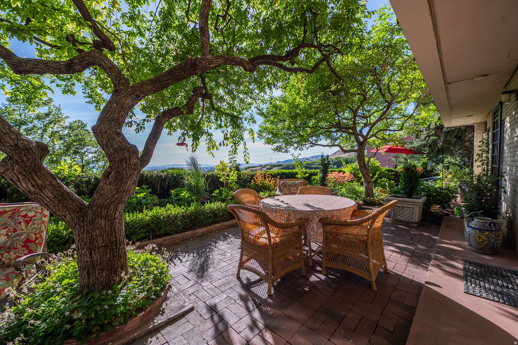 Nestled against the hillside with sweeping valley views, this exceptional turn-key residence offers a rare blend of luxury, privacy, and timeless design. Rich hardwood floors, custom built-ins, elegant millwork, and European-inspired finishes create a sophisticated yet inviting atmosphere throughout.  The true centerpiece is the expansive private patio which creates an outdoor retreat unlike any other in the community. Surrounded by mature trees and lush landscaping, it provides a level of privacy and outdoor living seldom found in condominium ownership. Whether enjoying a quiet morning beneath the canopy or entertaining guests in a stunning garden setting, this space is truly one of a kind.  Combined with resort-style amenities, secure access, beautifully maintained grounds, and a premier location near downtown, the University of Utah, and world-class recreation, this is a rare opportunity to enjoy refined living in one of Salt Lake City's most desirable communities.  Timeless design. Unmatched outdoor living. Spectacular views. Welcome home.