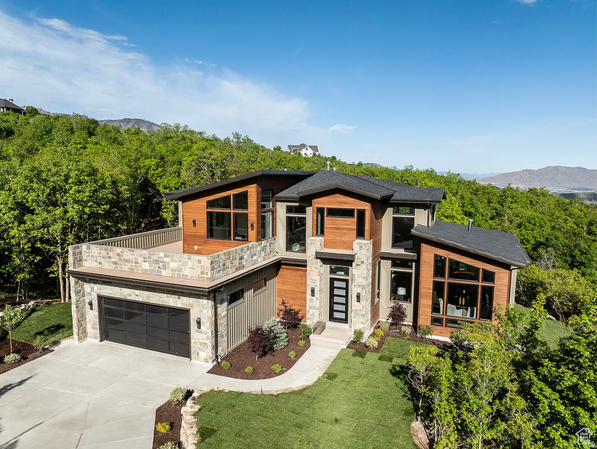 Experience elevated mountain living in this custom 2024 UV Parade of Homes' Fan Favorite, beautifully crafted residence set within one of Utah County's premier gated communities. Floor-to-ceiling slider doors, windows that look like art, a double-island kitchen with hidden outlets, double dishwashers, and a hidden sink anchor the open & practical layout. The home offers easy indooroutdoor living with an east-facing balcony for sun-bathing, a south-facing deck for sunsets over the valley (the place to be on the 4th of July!), plus an outdoor kitchen, firepit, hot tub, and a storage/flex room. The backyard will become your very own private, wooded oasis. Inside, you'll also find three fireplaces, an open-concept movie theater, and a fitness studio. The design combines clean architectural lines, natural stonework, and warm materials for a modern organic feel. Statement lighting and thoughtful details tie the spaces together. This home offers refined comfort alongside Summit Creek's resort-style amenities-including pools and hot tubs, pickleball courts, a state-of-the-art fitness center, an elegant clubhouse, and miles of scenic trails. Residents enjoy both seclusion and convenience with quick access to Sundance skiing, Provo Airport, top medical facilities, shopping, and dining. A rare opportunity to own a luxury mountain home where nature, design, and everyday ease come together.