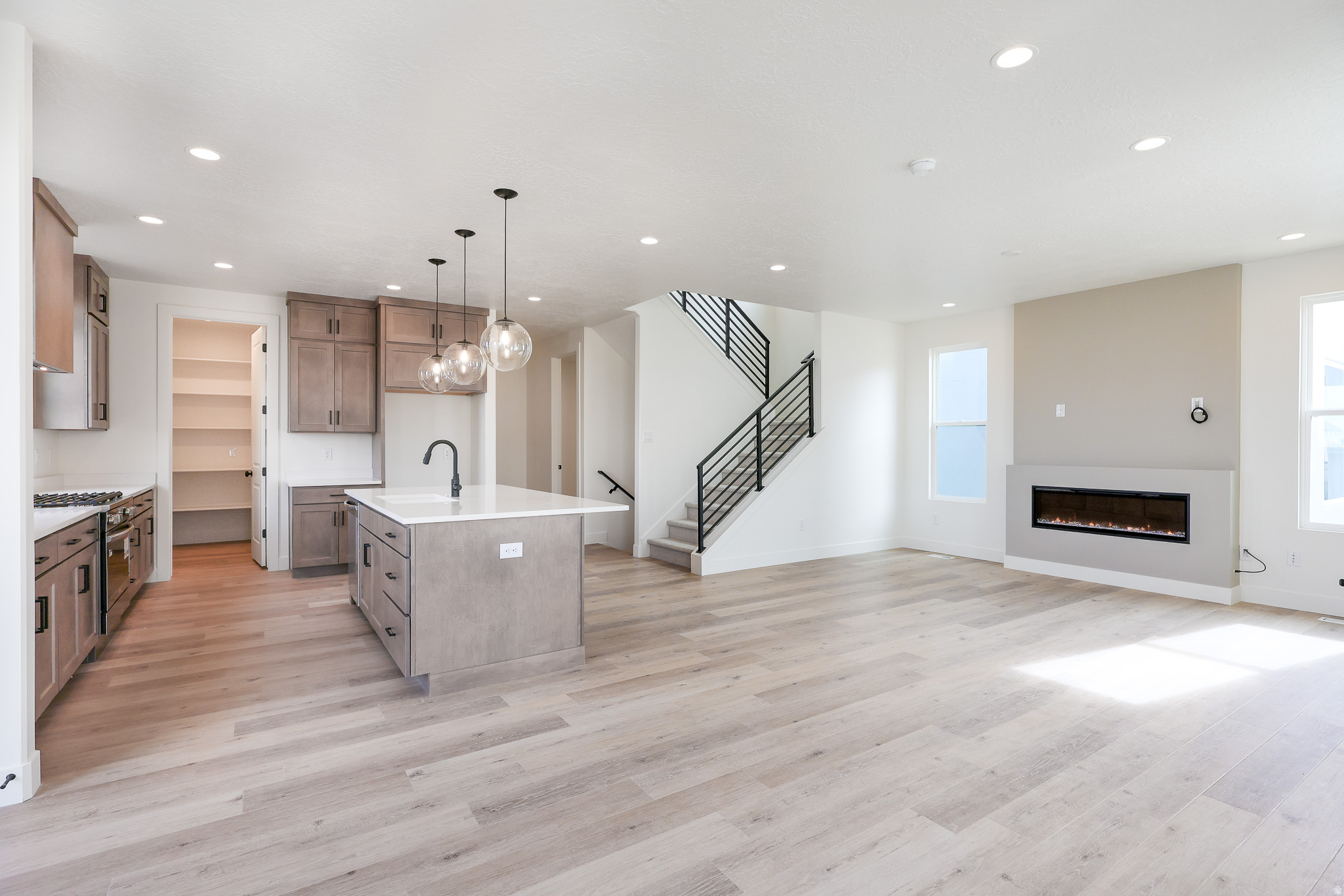 3% Preferred Lender incentive! Move-In Ready, Move-In Ready, Brand new home featuring a FINISHED BASEMENT and a landscaped backyard enclosed by a 6-ft privacy fence. This property offers a perfect blend of modern design, comfort, and functionality. Step inside to discover 9-ft ceilings on every level, a main-floor dedicated office or bedroom ideal for remote work or study, and an upgraded kitchen complete with high-end finishes, perfect for both everyday living and entertaining. Upstairs, the spacious primary suite includes a private balcony and an en-suite bathroom with tile shower and spacious closet. Large windows throughout the home fill each room with natural light, enhancing the clean lines and open spaces of this thoughtfully designed layout. Located in the desirable Watermark Village, the home features green space out front and convenient access to parks, trails, and the Watercourse, all just minutes away. Photos of actual home.