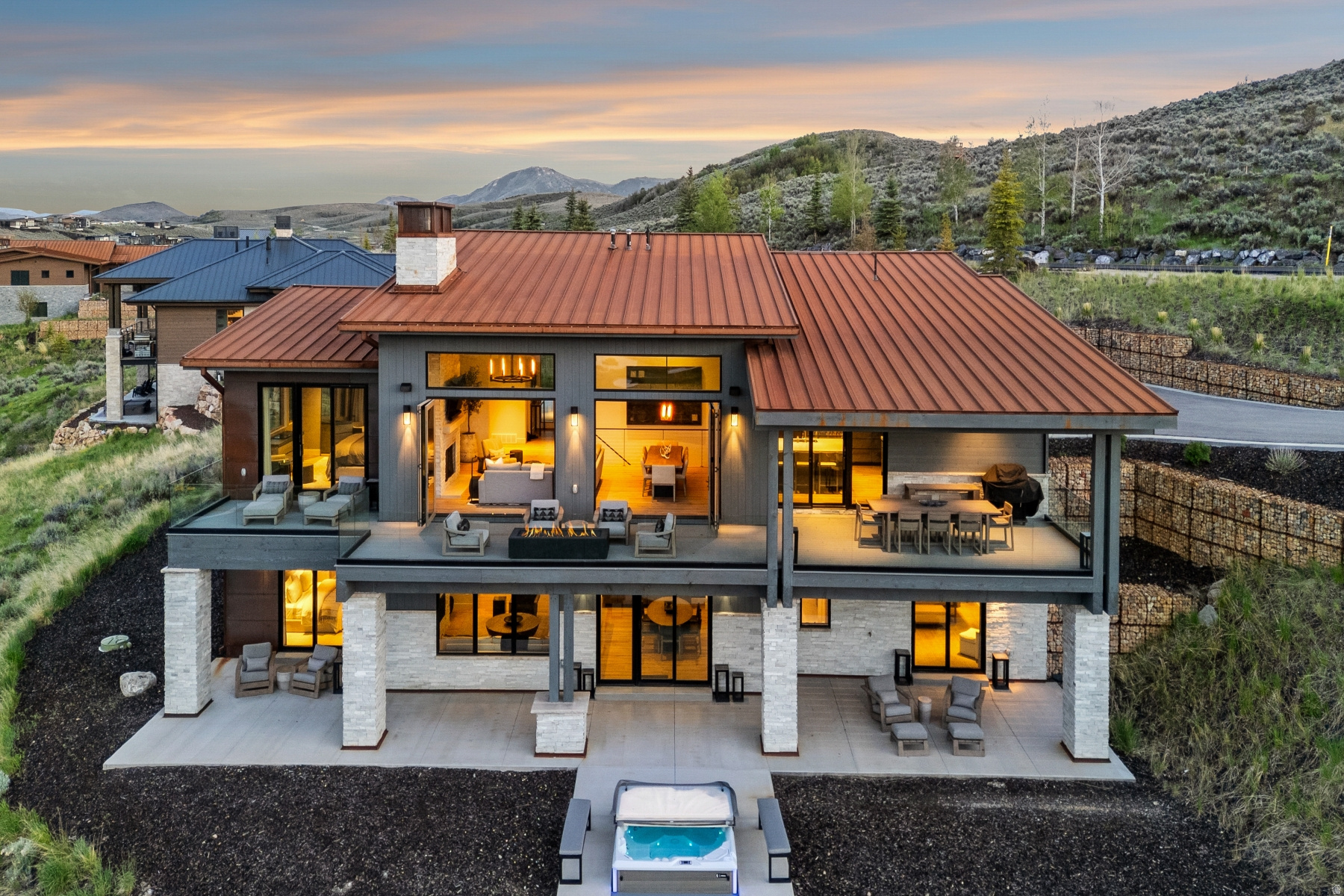 Exceptional Painted Valley Retreat with Panoramic Views -- Perched above the 1st fairway of Promontory's renowned Painted Valley Golf Course, this exceptional 5-bedroom mountain retreat captures idyllic golf, water, and mountain views from one of the community's most coveted settings. Completed in late 2022 and thoughtfully finished throughout, the residence showcases a fully enhanced entertainer's kitchen, designer-appointed bathrooms, sophisticated finishes, and custom details curated to maximize natural light and create a seamless connection to the surrounding landscape. The main level features a serene primary suite alongside a flexible guest suite with office, providing the convenience of single-level living. The lower level is designed for recreation and relaxation, offering a spacious family room, three additional bedrooms-including a custom bunk room-and a private golf simulator for year-round enjoyment. Retractable glass sliders blur the line between indoors and out, opening to expansive outdoor living spaces highlighted by glass railings that preserve elongated views and a centrally positioned hot tub that serves as the perfect backdrop for aprs-golf evenings and mountain sunsets. Offered fully furnished with curated Restoration Hardware furnishings in its entirety, the residence delivers a turnkey ownership experience without compromise. An oversized 3-car garage provides abundant storage for vehicles, golf carts, and mountain gear. Beyond the home itself, the location is among the most desirable in all of Promontory. Enjoy a short five-minute walk to the Painted Valley driving range, Spa at Promontory and fitness center, a two-minute stroll to the Beach Club, and easy access to Promontory's extensive trail system and club amenities. The recently completed Browns Canyon exit places Deer Valley East and Park City within remarkably convenient reach, making both weekend escapes and full-time mountain living effortless.