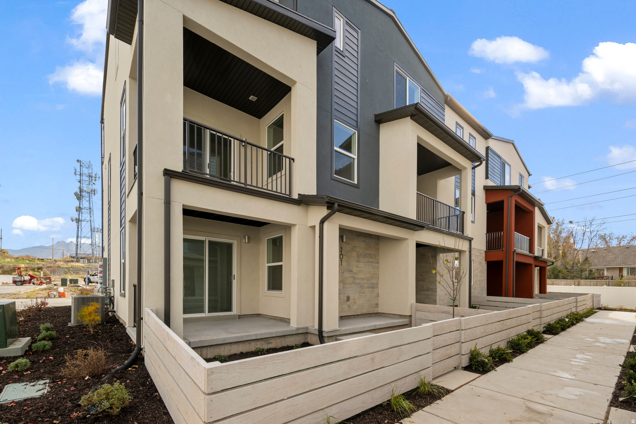 Welcome to easy living in one of Murray's most convenient locations. Nestled in the heart of the Salt Lake Valley, this community offers quick access to I-15, I-215, downtown Salt Lake City, the airport, local schools, parks, shopping, and the scenic Jordan River Trail.  This sought-after end-unit townhome is filled with natural light thanks to windows on three sides and features a fenced front yard, oversized patio, and private balcony-giving you multiple spaces to relax, entertain, or enjoy the fresh air. A subtle west-facing mountain view adds to the home's appeal.  Inside, the thoughtfully designed floor plan offers spacious living areas and a large open kitchen with stylish dark gray cabinetry, creating the perfect setting for both everyday living and hosting friends and family.  Built with efficiency and comfort in mind, this home includes enhanced insulation, energy-efficient windows, instant hot water, a programmable thermostat, solar-ready wiring, and a private garage equipped with an EV outlet-helping you save on utility costs while enjoying a more comfortable home year-round.  Residents enjoy access to community green space, a playground, BBQ gathering area, and plenty of guest parking. If you're looking for a low-maintenance home with modern features, abundant natural light, and an unbeatable location, this is an opportunity you won't want to miss. Call or visit our model home today!