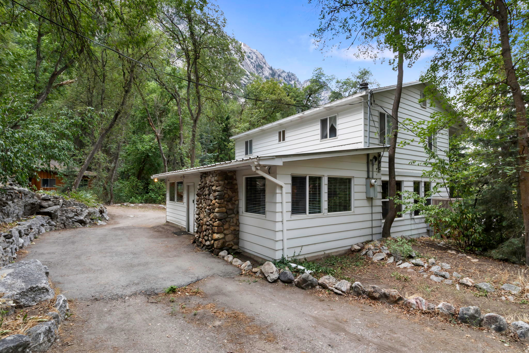 Rarely available in Little Cottonwood Canyon, this charming family cabin is nestled within the popular Wasatch Resort community and surrounded by breathtaking mountain scenery. Featuring 4 bedrooms, 2 bathrooms, and a separate recreation room, the cabin offers plenty of space for gathering with family and friends after a day of skiing, hiking, or exploring the canyon.  The terrific outdoor play area adds even more room to enjoy the mountain setting, complete with an outdoor fireplace and horseshoe pit for relaxing, entertaining, and making memories together. Take in beautiful views of the surrounding mountains and dramatic granite face from this peaceful alpine retreat.   With its inviting layout, flexible living spaces, and exceptional location near world-class recreation, this is a rare opportunity to own a true mountain getaway in one of Utah's most sought-after canyons.