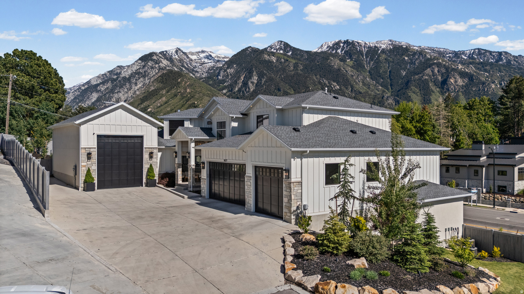 Perched against the breathtaking backdrop of the Wasatch Mountains and nestled near the mouth of Little Cottonwood Canyon, this extraordinary luxury estate offers an unmatched combination of elegance, comfort, versatility, and unforgettable views. From nearly every room, walls of windows frame stunning mountain vistas, creating a serene retreat that feels both private and connected to Utah's natural beauty. Designed for elevated living and exceptional entertaining, the heart of the home features a spectacular chef's kitchen complete with premium high-end appliances, expansive gathering spaces, and seamless indoor-outdoor flow to a covered deck where sunsets over the mountains become part of everyday life. Whether hosting large celebrations, relaxing around the fire pit, enjoying the hot tub under the stars, or entertaining guests with outdoor dining and music, every detail was thoughtfully designed to create memorable experiences The home offers an incredible lifestyle for all, featuring a dream playroom where imagination comes to life, a stunning theater and game room for movie nights and gatherings, and beautifully curated living spaces throughout that blend sophistication with warmth. One of the property's most exceptional features is the attached private ADU / mother-in-law apartment with both interior and exterior private entrances, offering incredible flexibility for multigenerational living, guest accommodations, executive housing, or rental income potential. This beautifully appointed separate living space includes three spacious bedrooms, a full kitchen, living room, mudroom, laundry, and private living quarters that feel like a home of their own. Car enthusiasts, adventurers, and hobbyists will appreciate the expansive RV garage and 6-car garage capacity, complete with ample storage, oversized depth, and additional side parking pad ideal for RVs, boats, trailers, or recreational vehicles. Every inch of this residence showcases quality craftsmanship and intentional design - from luxurious finishes and expansive entertaining spaces to practical amenities that support modern living at the highest level. Combining mountain luxury, privacy, functionality, and breathtaking scenery, this remarkable Sandy estate is truly a rare opportunity to own one of the area's most exceptional homes. Buyer / buyer agent to verify all