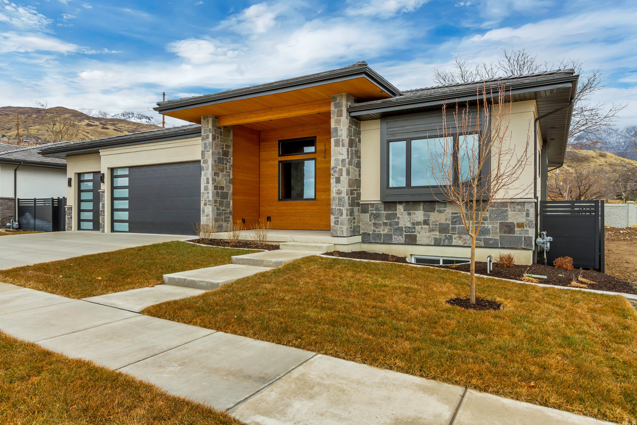 To-be-built semi-custom home in Abbey Road, a boutique NE Orem community near Provo Canyon, Murdock Trail, Harmons, University Place, BYU, UVU, and the foothills of Mt. Timpanogos. The Ringo plan offers approximately 5,300 sq ft with a 3-car garage and 4 bedrooms standard, including one bedroom on the main level and three bedrooms in the finished basement. The current base price includes a high-quality Whitehaven Builders finish package with an open main level, chef-style kitchen, generous island, walk-in pantry, designer consultation and assistance, finished basement, theater prewire, smart-home features, premium windows, high-efficiency multizone HVAC, upgraded insulation, insulated garage, epoxy-coated waterproofed garage floor, hot/cold garage hose bib, EV-ready 220V outlet, full landscaping, and fencing. Buyers may customize further, including finish selections and potential structural changes such as adding bedrooms, bathrooms, or other plan modifications, subject to builder approval, lot fit, engineering, and construction timing. HOA provides lawn care and snow removal for a low-maintenance lifestyle. Photos show previously completed homes and are for example only. Final pricing, features, allowances, and build timeline to be verified with builder.