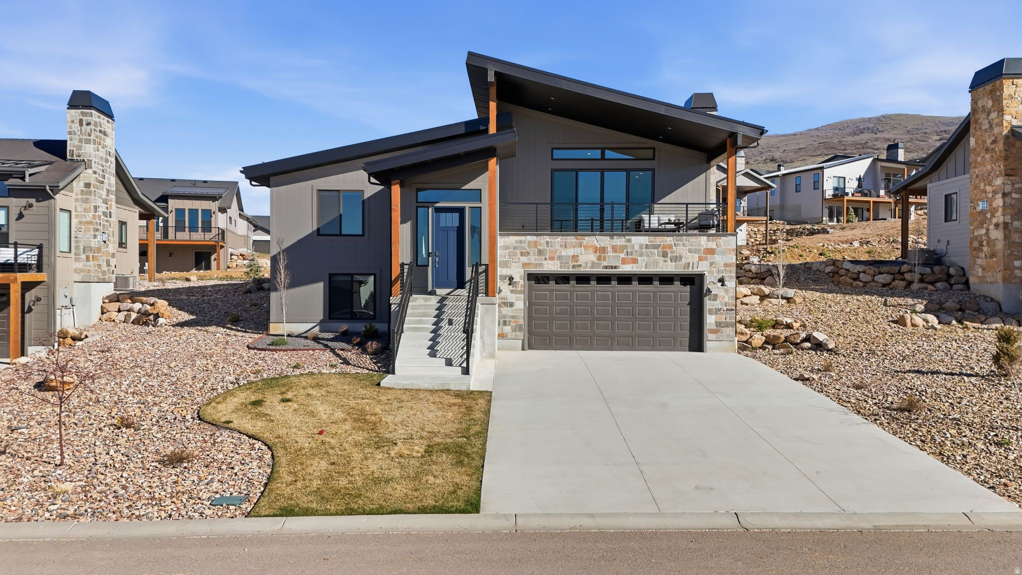 Tucked into the highly sought-after Eden Valley, this fully furnished, like-new mountain modern home offers the perfect blend of luxury, comfort, and year-round adventure. Ideally positioned just minutes from Powder Mountain, Snowbasin, and Nordic Valley, you are surrounded by some of Utah's premier skiing, snowboarding, hiking, and biking terrain, while Pineview Reservoir sits just down the road for boating, paddleboarding, and summer recreation.  Thoughtfully designed with an open-concept layout and soaring vaulted ceilings, the main living space is both inviting and functional. The kitchen features sleek finishes, ample cabinetry, and a large island that flows seamlessly into the dining and living areas-perfect for entertaining or relaxing after a day on the slopes. Expansive windows, complete with custom blinds, fill the home with natural light while capturing the surrounding mountain landscape, and the cozy fireplace creates the ideal setting to unwind year-round.  The primary suite is a true retreat, offering a spa-like bathroom with a walk-in shower and refined finishes, while additional bedrooms and bathrooms provide flexible space for guests, family, or rental potential. The lower level is designed for gathering and recreation, complete with a spacious second living area that easily accommodates additional sleeping arrangements, making it ideal for hosting larger groups.  Step outside to enjoy the covered deck and private outdoor spaces, where you can take in the peaceful surroundings and fresh mountain air. A hot tub adds the perfect touch for relaxing aprs-ski evenings or quiet mornings with a view.  Offered fully furnished and completed in 2024, this home is truly turnkey-whether you're looking for a primary residence, second home, or investment opportunity. The garage is equipped with a Tesla charger, adding modern convenience for electric vehicle owners. Located just under an hour to Salt Lake City and the international airport, this is a rare opportunity to own in one of Northern Utah's most desirable outdoor destinations, where world-class recreation and modern mountain living come together seamlessly.