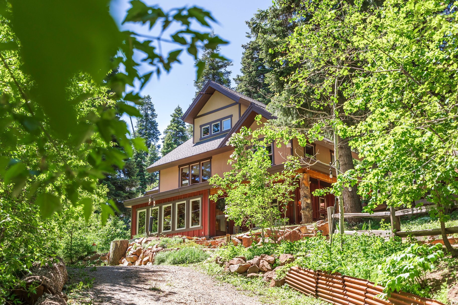For a true mountain retreat within minutes of Salt Lake City, nothing compares to this opportunity in Emigration Canyon's most authentic mountain neighborhood, Pinecrest. Set among mature trees alongside a flowing creek, this home enjoys a romantic setting where all you can hear are the sounds of the forest and the creek flowing down the canyon. City life feels a world away but is just minutes down the road. Inside, the vibe is warm and inviting, filled with natural light and a modern cabin aesthetic. Floors are radiantly heated throughout, with polished concrete floors in the great room surrounded by cedar-clad walls. Four bedrooms are spread across three levels, including a main-level suite, a second-story primary suite with walk-in closet, claw-foot tub, and private deck overlooking a fire pit, two additional second-story bedrooms sharing a charming bathroom, and a spacious third-floor loft that works equally well as a game room, studio, or fifth sleeping space. In 2009, the home was rebuilt into the timeless treehouse that you see today, preserving only a small portion of the previous structure. In the past few years, the solar panels, boiler, water softener, and many appliances were replaced, and the roof was partially replaced as part of the solar upgrade, which has been paid off. Now you can enjoy your new canyon retreat from day one with peace of mind and low maintenance. When you live in Emigration Canyon, you are just up the road from the University of Utah, Rowland Hall, and downtown Salt Lake City, with convenient access to I-80 for the airport, nearby ski resorts, and Mountain Dell Golf Course. What attracts buyers most, though, is the authentic mountain lifestyle with year-round wildlife and out-your-door access to snowshoeing and backcountry skiing in winter, and some of the best hiking, mountain biking, and cycling in the spring, summer, and fall.