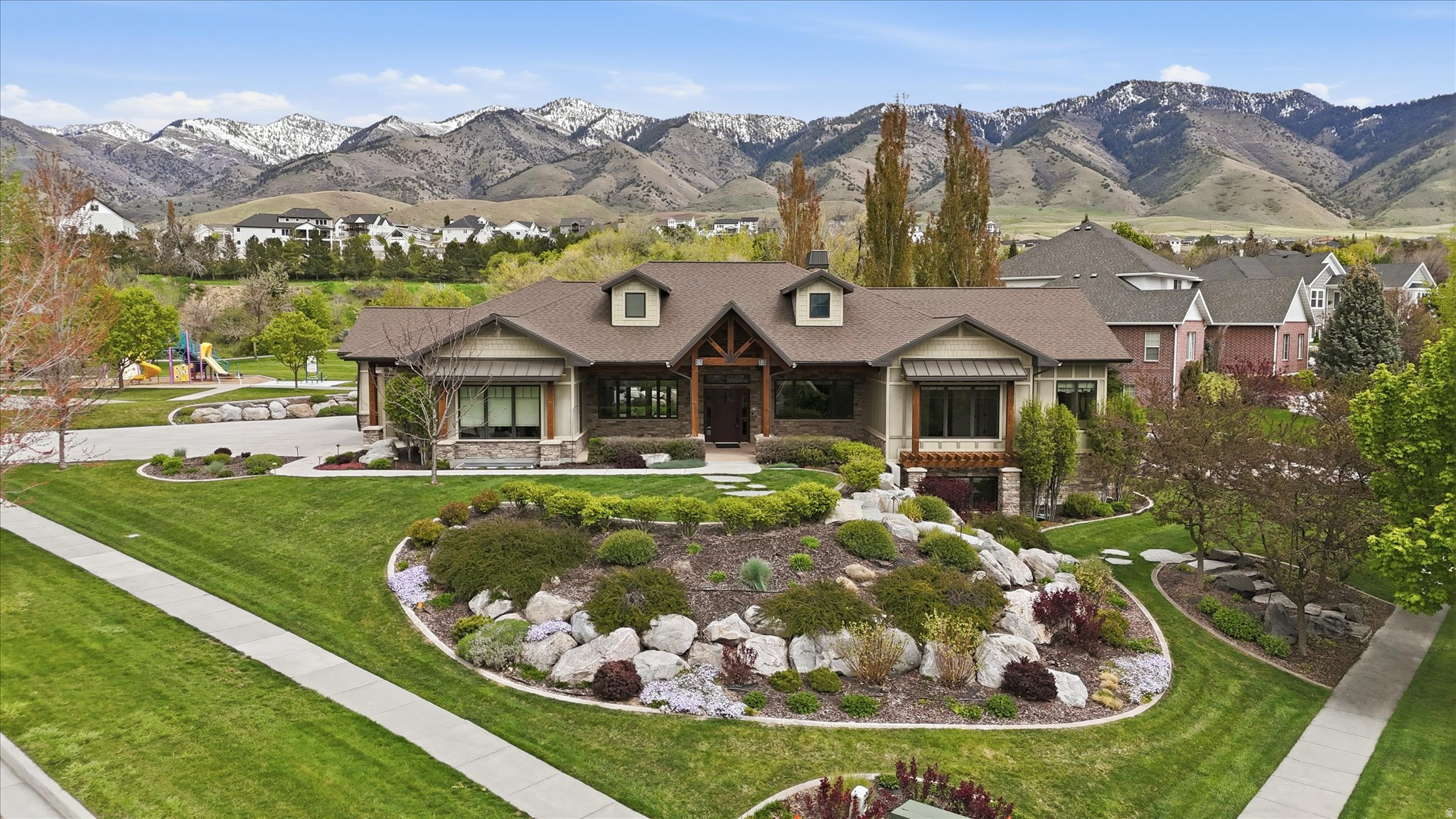 LUXURY HYDE PARK BENCH HOME WITH VIEWS! Located in Shadow Bluff Estates, this stunning rambler offers 5,172 sq. ft., 7 bedrooms, 5.5 bathrooms, 3 laundry areas, and a 3-car garage on a fully landscaped 0.43-acre lot. Enjoy breathtaking mountain and valley views, tall and vaulted ceilings, hardwood and tile flooring, granite countertops, geothermal heating/cooling, central vacuum, ceiling speakers, and a spacious primary suite with a separate tub/shower and walk-in closet. Need relaxation? Indoor hot tub room with warm wood finishes, expansive glass doors, awaits-perfect for year-round relaxation. Want to entertain? A rare indoor barbecue room elevates the home's entertaining space with a built-in grill, professional-style hood, granite surfaces, prep sink, refrigerator, and seamless access to the patio and backyard views. The fully finished basement includes an attached ADU/mother-in-law apartment with a separate entrance-perfect for extended living or guest space. Outdoor features include a covered patio, open porch, dreamy landscaping throughout with a stream feature and auto sprinklers, plus beautiful Cache Valley views. Strategically positioned next to a small park, this home offers the unique opportunity to enjoy the added open space without the maintenance. Close to schools and hospitals, and only 7 minutes to USU! Elegant, functional, and truly one of a kind!