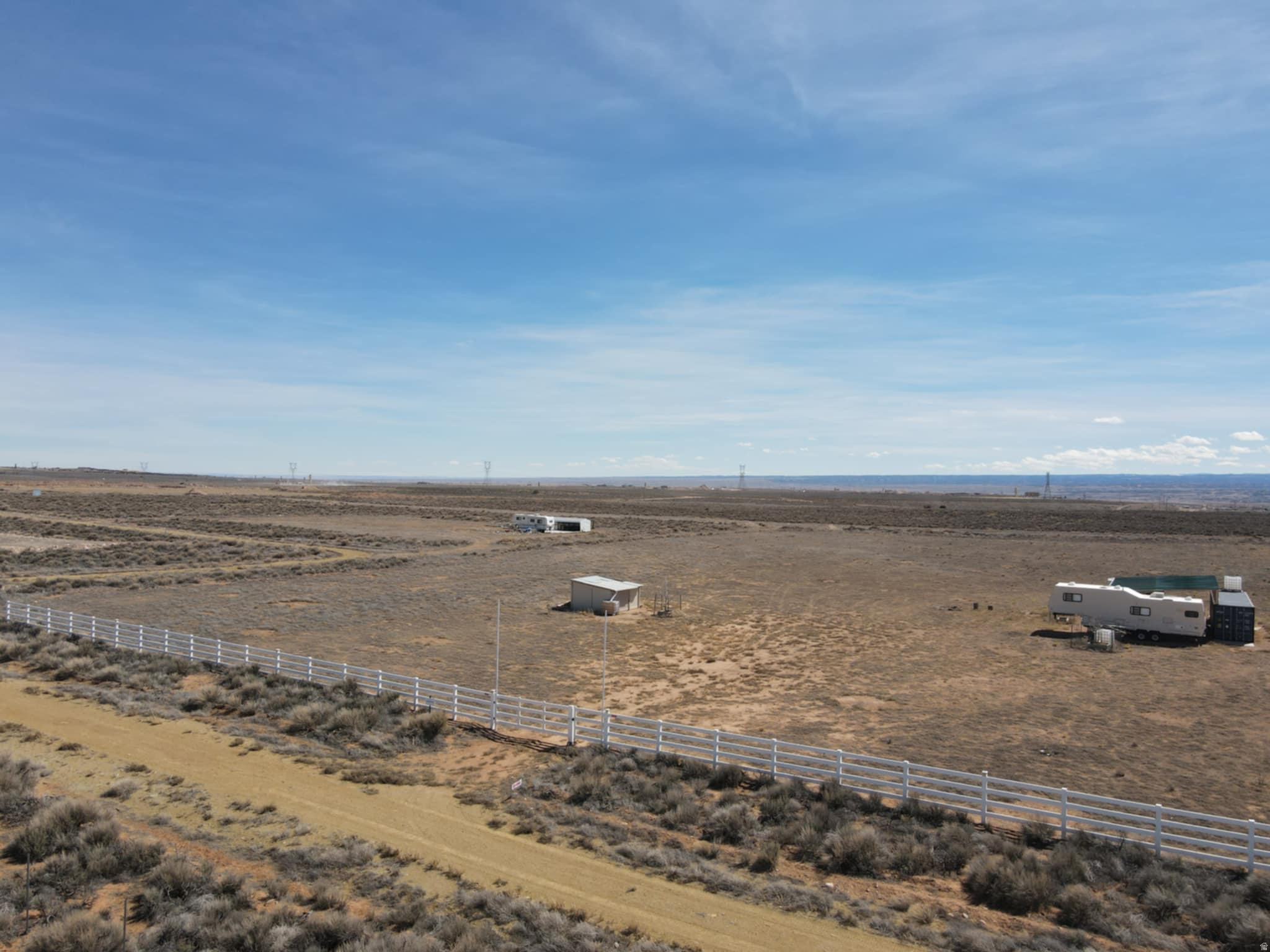 Discover the perfect getaway on this beautiful 5-acre property, thoughtfully prepared with designated camping areas for unforgettable family experiences. As a bonus, for just an additional $6,000, you can own both RV trailers currently on-site-ready for immediate use. Plus, a storage container is included with the property! Google Maps; https://maps.app.goo.gl/yQ2jTseftL3utddYA - 40.250607, -110.346193
