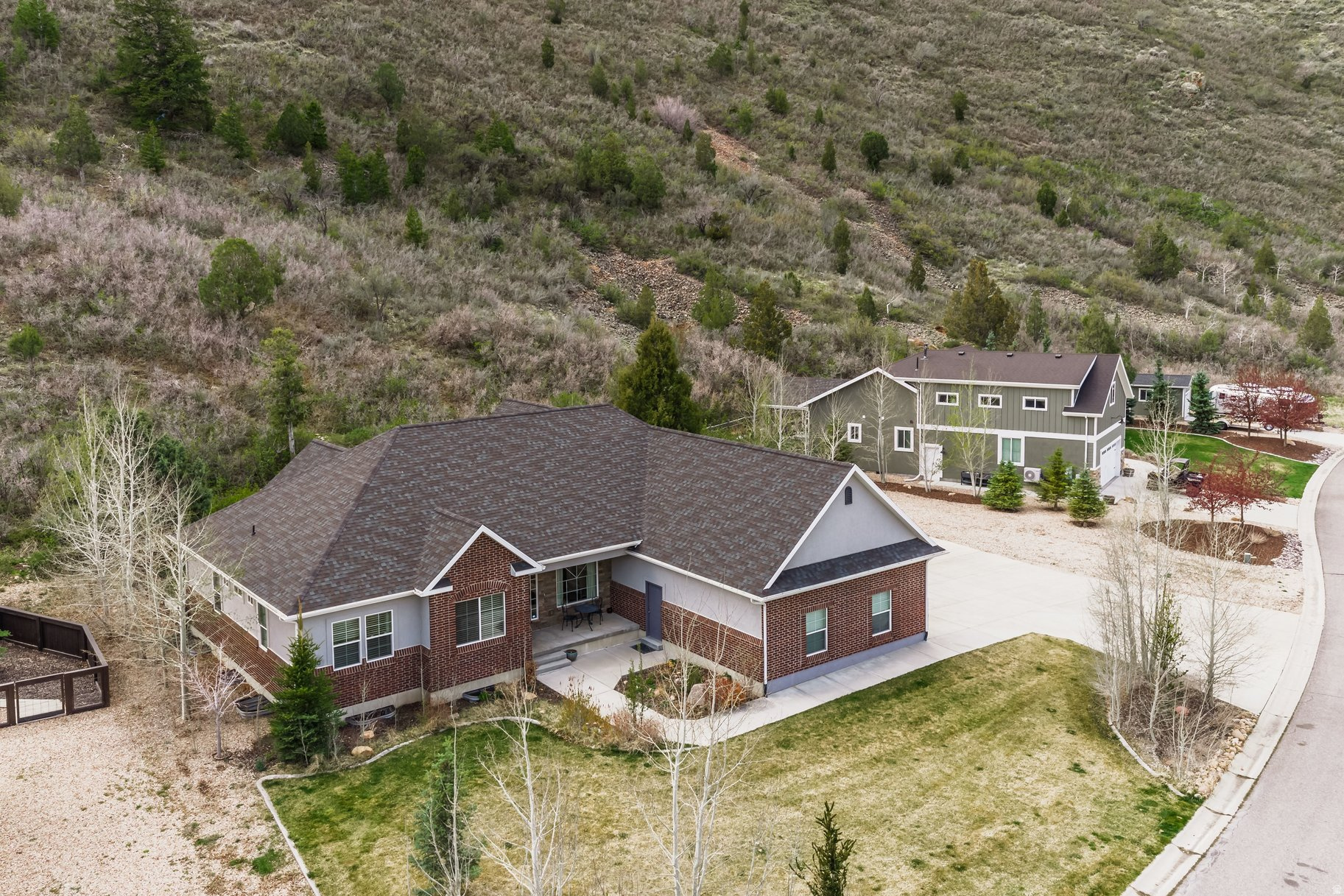 Set on just under an acre in one of Kamas' most peaceful settings, this six-bedroom residence offers a rare sense of privacy with unobstructed mountain views and open space stretching beyond your backyard. Thoughtfully positioned with no rear neighbors, the home captures the quiet beauty of its surroundings while remaining effortlessly connected to nearby amenities. The open-concept main level is designed for both refined living and comfortable gathering, anchored by a spacious kitchen with warm wood cabinetry, an expansive island, and a natural flow into the dining and living areas. Oversized windows frame the landscape and fill the home with soft, natural light. With three bedrooms on the main level and three on the lower level, the layout offers flexibility for a variety of lifestyles. The lower level includes an oversized bedroom that was originally designed as a second living space, allowing easy conversion back to a family room or media area. Enjoy a covered patio and a serene backyard setting, complemented by a three-car garage and ample parking for RVs, trailers, and all your outdoor toys. Ideally located less than a mile from South Summit schools and the start of Mirror Lake Highway, with convenient access to Park City.