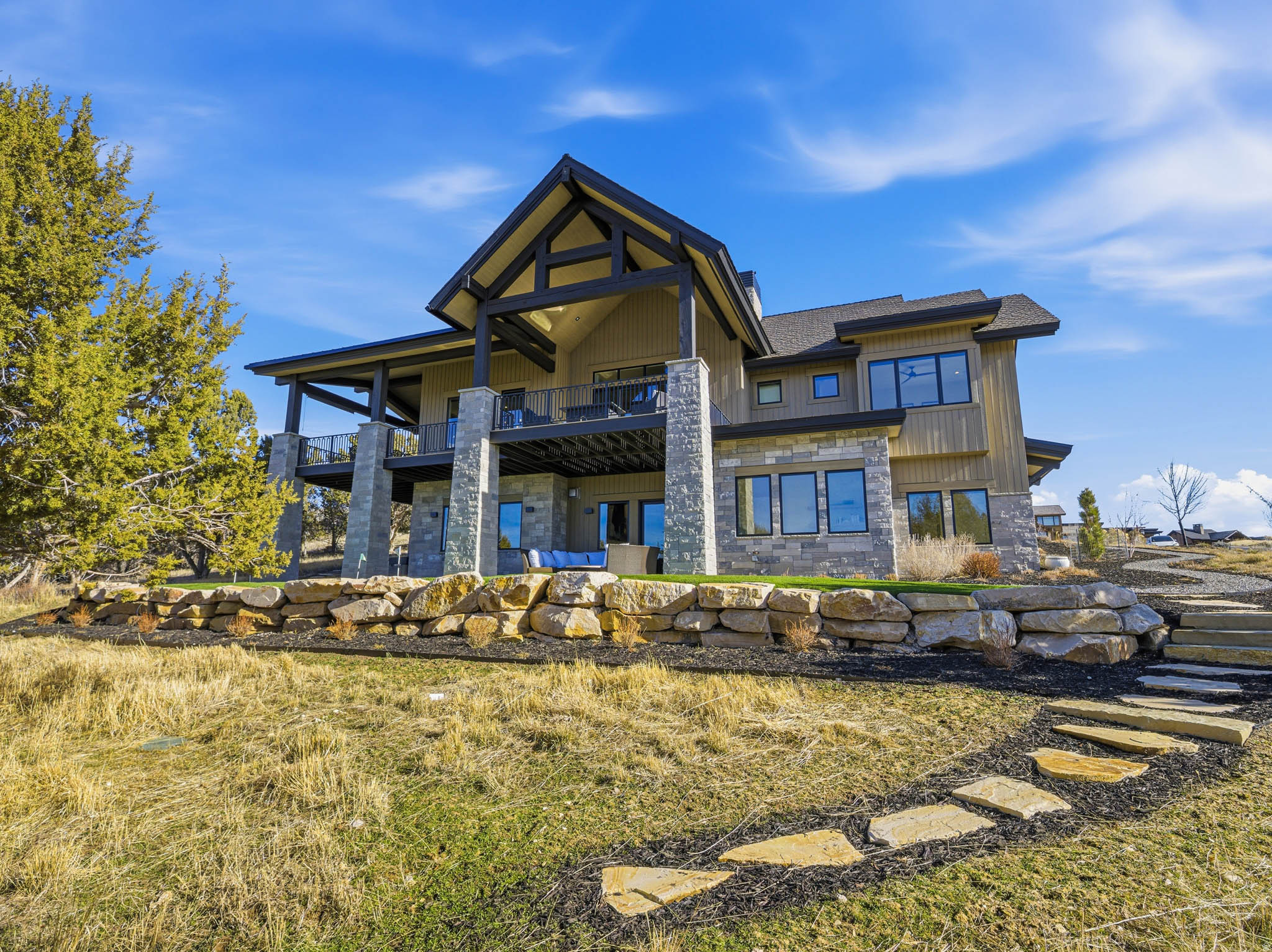 RARE LIMITED TIME OPPORTUNITY!  In anticipation of an international relocation, sellers are offering an extraordinary opportunity.... FURNISHINGS INCLUDED PLUS $100K TOWARDS RED LEDGES GOLF MEMBERSHIP with an offer and closing in June.   Exceptional opportunity for a turnkey lifestyle at Red Ledges, an affluent, award-winning mountain community offering a lifestyle truly unlike any other. Residents enjoy world-class amenities including the prestigious Jack Nicklaus Signature Golf Course, elegant clubhouse, state-of-the-art wellness center, equestrian facilities, three resort-style pools, tennis and pickleball courts, miles of hiking and biking trails, and a dedicated children's center. Enjoy an exclusive shuttle in the winter providing transportation every 20 mins to Deer Valley ski resort and access to on-mountain ski lodges.  Situated on the 6th green, this exceptional residence is surrounded by professionally designed landscaping with an abundance of blooming flowers and sweeping natural beauty. The property captures breathtaking views of Mount Timpanogos, the surrounding valley, and unforgettable sunrises and sunsets. With no neighboring homes directly in front, behind, or to either side, the setting offers a rare sense of privacy and a true mountain retreat experience.  Inside, expansive windows frame the views and flood the home with natural light. The gourmet kitchen is appointed with exquisite marble countertops, top-of-the-line Wolf and Sub-Zero appliances, and a well-designed butler's pantry, ideal for both daily living and entertaining. The primary suite is a private sanctuary, featuring serene views and a recently remodeled spa-like bathroom. Additional living spaces include four spacious ensuite bedrooms, two family rooms, an office,a dedicated craft room, and a sunroom with multiple possibilities. An indoor sports court allows for year-round basketball or pickleball enjoyment, adding a unique recreational element rarely found in residential homes. Luxury and functionality continue with a whole-house backup generator, electric window shades, Lutron lighting system, VSSL whole-house audio, a personal putting green, and an expansive garage accommodating up to five vehicles or an RV. All information herein is deemed reliable but is not guaranteed. Buyer is responsible to verify all listing information, including square feet/acreage, to buyer's own satisfaction.