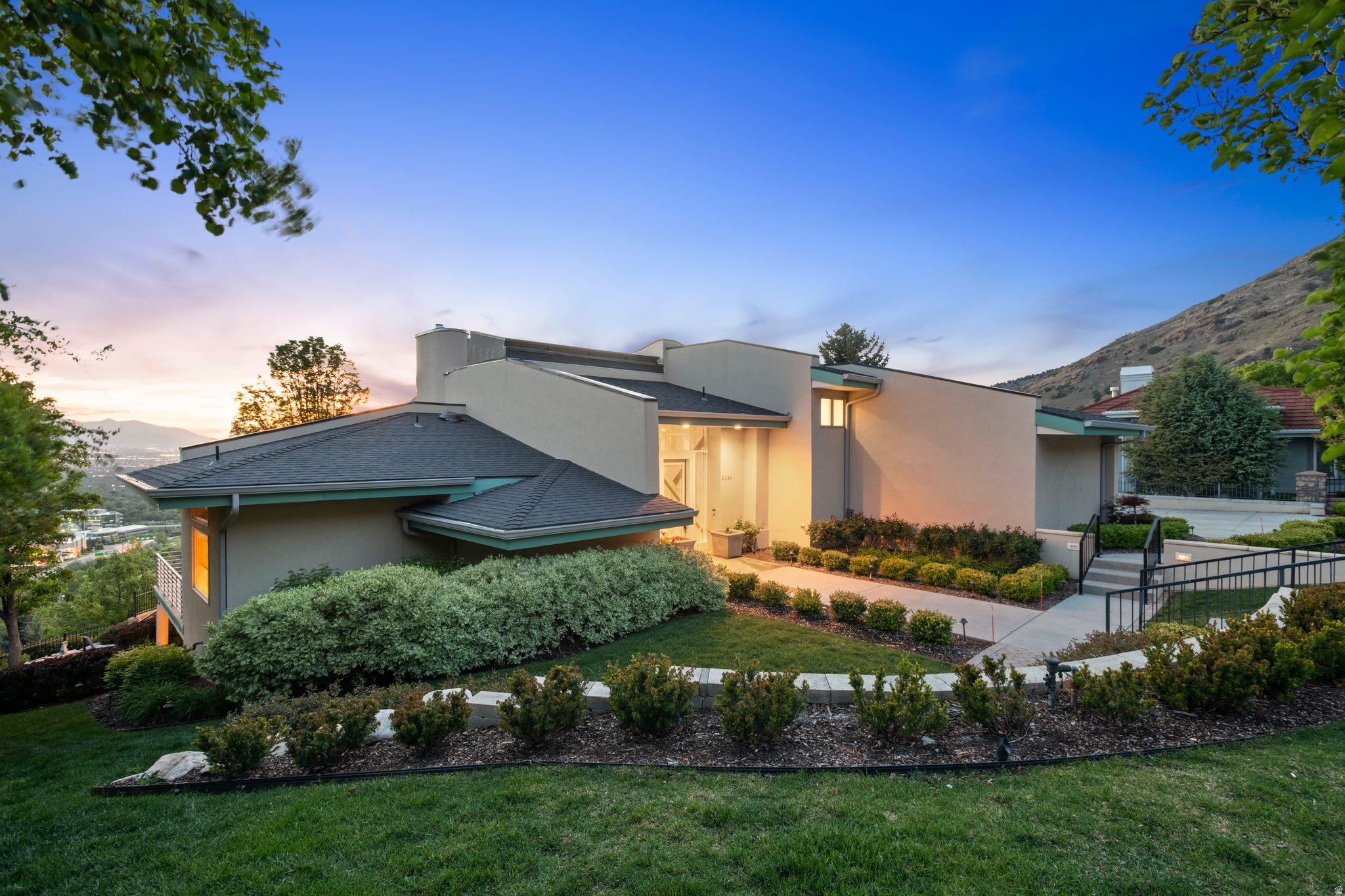 Beautifully maintained and extensively renovated, this stunning estate is nestled on 1 acre in the coveted Canyon Cove area of Holladay. Showcasing breathtaking valley views, the home has been thoughtfully transformed with extensive interior and exterior upgrades, creating a true luxury retreat. High-end finishes are featured throughout, and nearly every mechanical system has been updated for modern comfort and peace of mind. New skylights at the front of the home flood the interior with natural light, while expansive windows across the back capture spectacular views and sunshine throughout the day. Soaring ceilings throughout the home create an open, airy atmosphere filled with natural light, enhancing the spacious design and elegant architectural appeal.  This exceptional residence offers four spacious bedrooms, six bathrooms, and an incredible library/den perfect for relaxing or working from home. The grounds are a private oasis with beautifully designed paver paths and patios that create multiple sitting and entertaining areas, complete with a charming outdoor pizza oven for unforgettable gatherings. Please see attachment for list of improvements.   All information is deemed reliable, but is not guaranteed and should be independently verified.