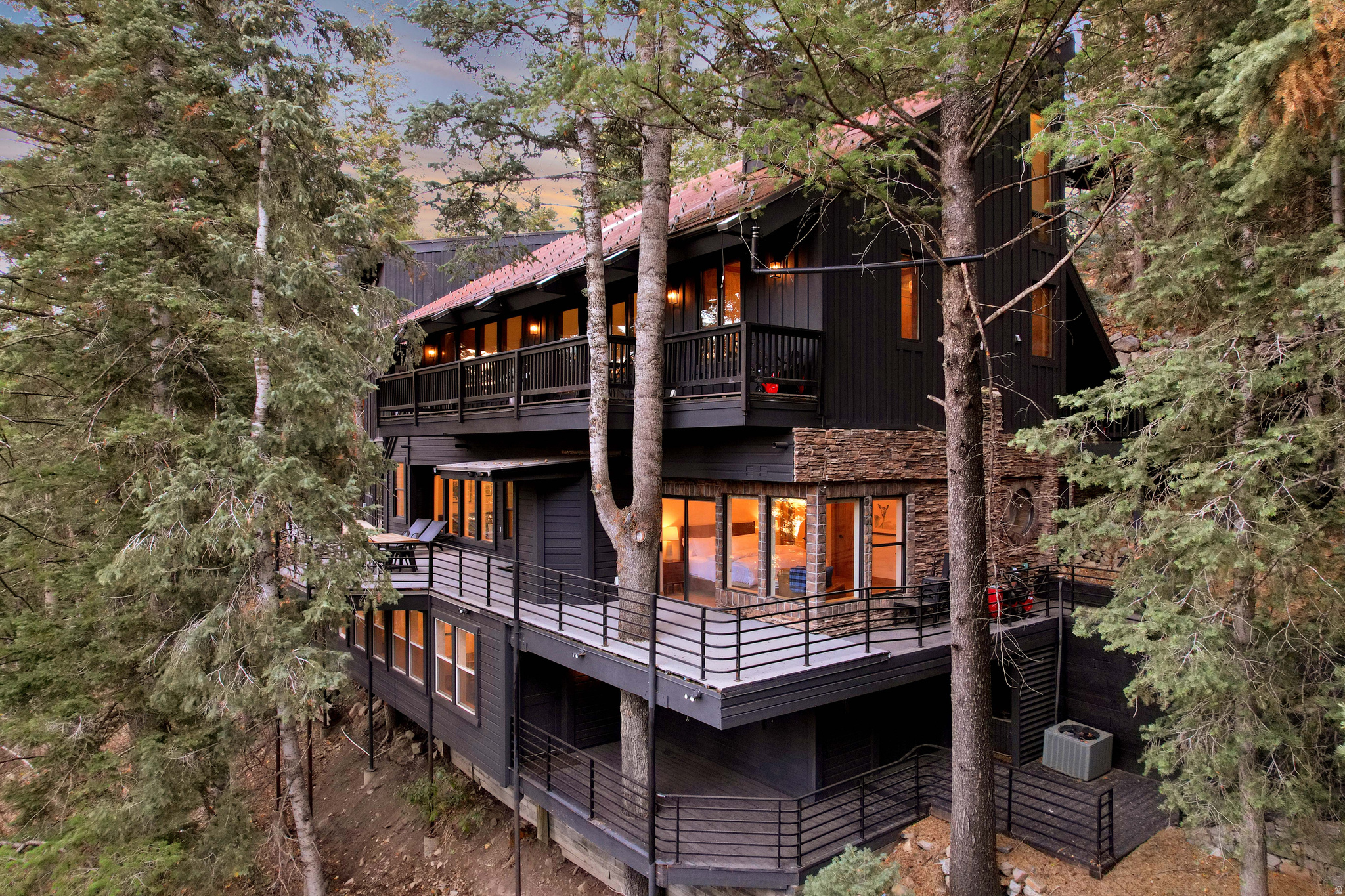 This one-of-a-kind mountain retreat within 100 yards of the nearest ski run, offers every amenity your family could want and is approved for short term rentals. Fully remodeled with vaulted ceilings, expansive decks and patios, and seamless indoor- outdoor living, this property allows you to take in the stunning natural surroundings from every angle. Multiple living areas, generous guest accommodations, en-suite bedrooms, and a secondary kitchen/accessory apartment make hosting effortless. The main residence is completed with a detached garage featuring a dedicated ski-locker room complete with built-in lockers and boot warmers, perfect for shedding layers and drying gear after a day on the mountain. The home also includes an impressive indoor sports court, allowing for year-round recreation with space for racquetball, basketball, pickleball, and more. Unique architectural elements and expansive skylights fill the home with natural light, enhancing its warm, elevated mountain design. This is where modern comfort meets timeless rustic luxury, with unmatched access to hiking, biking, skiing, and year- round recreation right outside your door. Enjoy all Sundance has to offer, including award-winning dining, a world-class spa, art studios, and scenic chairlift experiences, while Provo is just 20 minutes down the canyon for additional shopping, dining, and city convenience. Sundance is experiencing significant investment and growth, including expanded ski terrain, upgraded lift infrastructure, a state-of-the-art day lodge, and a new luxury inn underway at the base area, enhancing the resort lifestyle and strengthening long-term value in this highly sought-after community. Whether you're seeking a primary residence, a private mountain getaway, or a premium rental opportunity, this rare offering delivers privacy, recreation, and an unparalleled mountain lifestyle in one of Utah's most exclusive alpine destinations