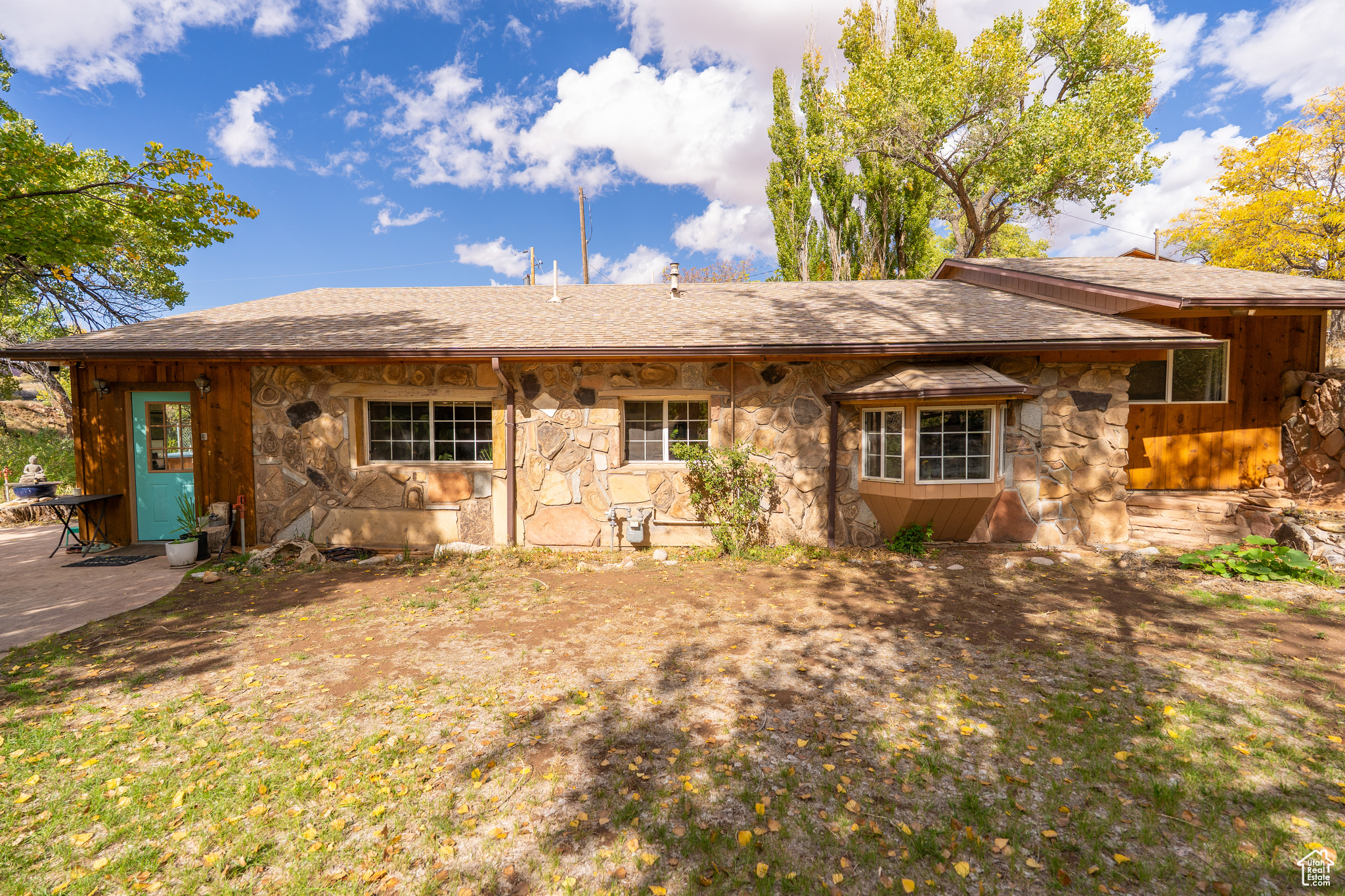 Tucked away on 1.26 serene acres, this one-of-a-kind 4-bedroom, 2-bath home offers the perfect blend of privacy, charm, and natural beauty. Just minutes from the golf course, Old City Park, and scenic hiking trails, this hidden oasis has Pack Creek running right through the property - bringing the soothing sounds of nature to your backyard. Enjoy evenings under the shade trees or relax on the patio in your private hot tub. The fenced backyard, two detached garages, and hillside acreage offer endless possibilities for outdoor living and adventure. Inside, you'll find an inviting open floor plan, a formal dining room, stonework, and unique architectural touches. Peaceful, private, and full of character - this one is a must see!