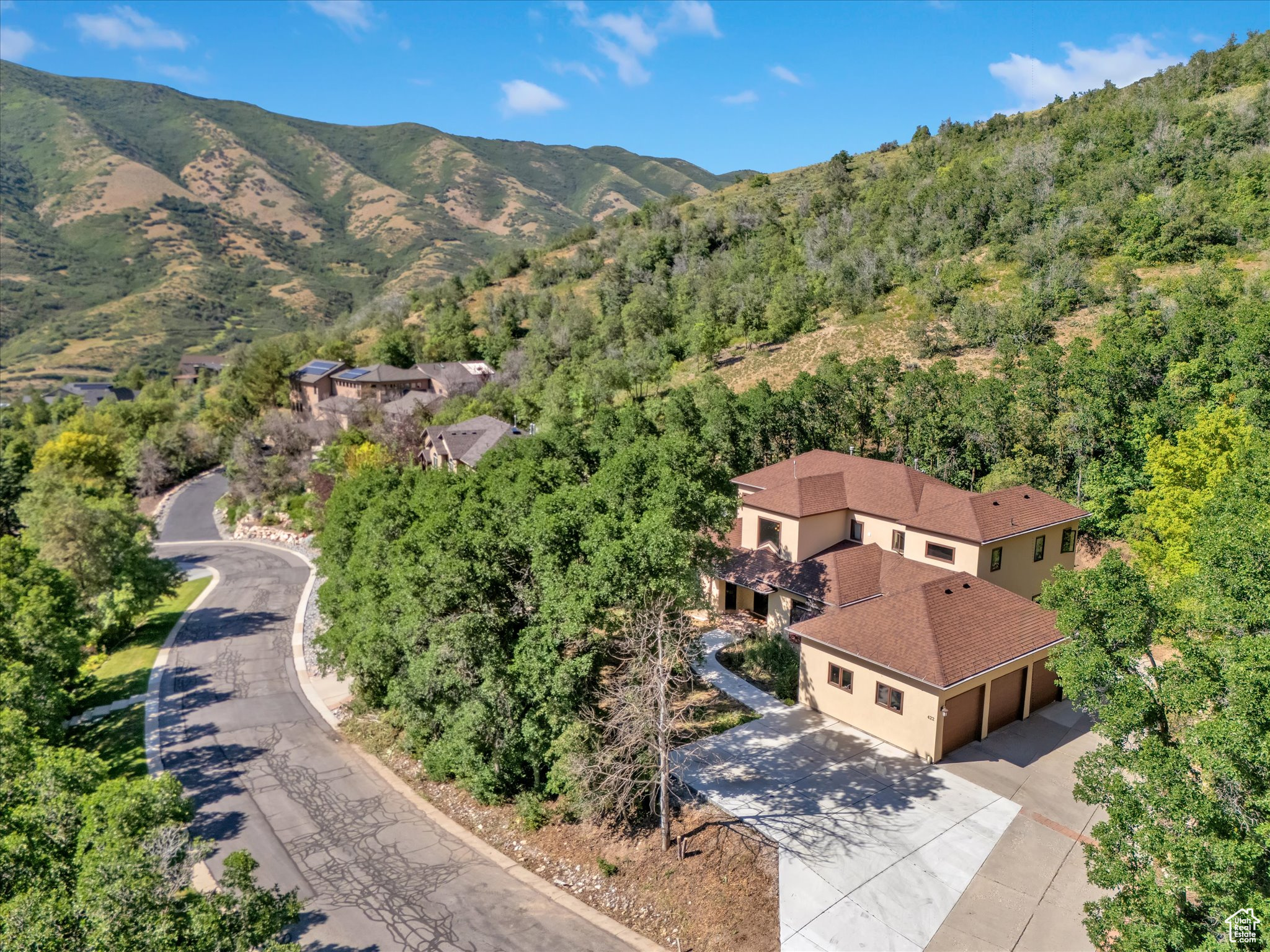 *Seller is offering up to $25,000 in concessions or towards the purchase price depending on terms and buyer's preference.* Nestled near the top of the gated community of Emigration Place, this spacious home invites you to enjoy the splendor of mountain living just minutes outside of Salt Lake City. With 5306 square feet, 5 bedrooms, 5 bathrooms, an office, multiple family rooms, and an elevator to provide ease of access to all three levels, there's room for every aspect of your lifestyle. The two-level entry invites you in with a sweeping stairway repurposed from a Salt Lake church and custom metal handrails which wrap around the glass and metal elevator. An oversized kitchen with two islands, a covered deck and formal and informal dining areas make entertaining a breeze. Upstairs another deck allows you to enjoy the beautiful sanctuary of Emigration Canyon just steps from your primary suite with fully renovated lux bathroom. A  junior suite completes the upper level. The basement features three more bedrooms, two full bathrooms, a theater room and additional family or game room. The 3-car garage with built in workbench is supplemented by additional parking for 3 more cars and the perfect spot for your camper or boat as you prepare to enjoy the outdoor recreation opportunities that surround you along the Wasatch front and back!