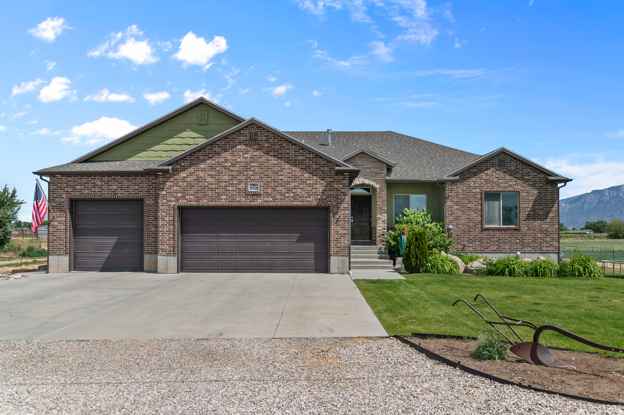 Beautiful ranch rambler that sits on 1.82 acres.  One neighbor to the west while surrounded by acres of farmed fields.  Perfect location for those who love lightly traveled roads, stunning nights without light pollution, and quiet seclusion.  2 new gas water heaters have been installed over the last 2 years (1- 50g and 1- 40g).   Water softener was installed 6 years ago so, it's newer technology and efficient.  Basement was remodeled/finished in 2021 along with basement and stairs getting new carpet and paint.  Large storage room in basement with multiple shelving for food or other items. Basement also has a walk-out to patio under deck.  CAT6 network cable installed in each room.   Gas stove, Gas or electric dryer, large pantry in kitchen.  Beautiful, hand-crafted kitchen cabinets, railing and hearth above fireplace.  Laundry room is located on main floor and next to the mudroom and garage to keep dirt out of the main house.  The master suite is large with his and hers walk-in closets, dual sink, walk-in shower with dual shower heads, large corner tub and secluded room with toilet.  2 car garage on one side and large deep garage on the other side.  Garage has large storage platform, hot/cold water spigot.  Outside provides a blank slate for you to make it your own.  What is existing: Large chicken coop that features a human side for all the food storage and egg gathering.  Front and rear of home has full auto sprinkling system that connects to your WiFi and app on phone.  Large, raised garden boxes with gravel walkways.   Asphalt drive and parking on west side of house.  Round corral with holding pen attached to it.  4 holding pens and another large area that is gated off for multiple animals.  All fencing is constructed with metal tub pipe; all gates are metal with easy-to-use heavy duty metal latches.  40X9X8 shipping container for exterior storage.  Water and electricity already ran to the rear of the property. Holding pens are plumbed for auto waterers with electricity. Kubota  L3901 tractor with box scrapper, 40g sprayer and drum aerator can be negotiated with purchase of home.