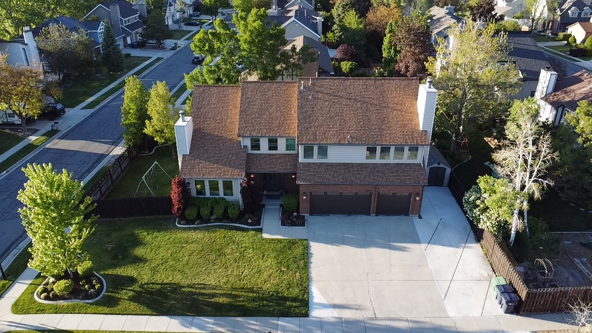 Under contract but accepting Backup offers.  WELCOME HOME to this fully remodeled 9-bedroom East Sandy corner-lot home featuring a luxury chef's kitchen, mountain views, and a SEPARATE INCOME PRODUCING Multigenerational apartment across 4,500 sf of updated living space. The SHOWPIECE KITCHEN was designed for entertaining with two oversized islands, quartz countertops, Sub-Zero refrigerator, Wolf appliances including three ovens and warming drawer, Bosch induction cooktop, double dishwashers, farmhouse sinks, in-ceiling speakers, dimmable and under-cabinet lighting, and abundant natural light. Open gathering spaces connect the kitchen to a spacious family room with a fireplace and French doors leading to the patio. The vaulted living room features new energy-efficient windows with automatic blinds and a second fireplace. Main level also includes a dedicated office/bedroom. The PRIMARY SUITE offers vaulted ceilings, mountain views, sitting area, fireplace, walk-in closet, and a luxury bath with two-person shower and heated towel rack. Upstairs includes four additional bedrooms and an updated full bath with double vanity. All bathrooms throughout the home have been remodeled. The walkout basement includes a Dolby Atmos-wired theater room/flex bedroom, 3/4 bath, and substantial storage. A separate 1,200 SF ADU, features a PRIVATE ENTRANCE, two bedrooms, 3/4 bath, a second full kitchen with Viking refrigerator, stacked washer/dryer, independent HVAC, waterproof flooring, and near-total sound isolation, ideal for rental income or multigenerational living. ADDITIONAL UPGRADES include new flooring and carpet throughout, insulated garage doors, new interior and exterior doors, frames, and hardware, tankless water heater, water softener with carbon filtration, concrete patio, mature landscaping with drip irrigation, heated exterior stairs and sidewalk, two additional parking spaces plus optional RV parking, Google Fiber, and roof inspected/serviced November 2025.
