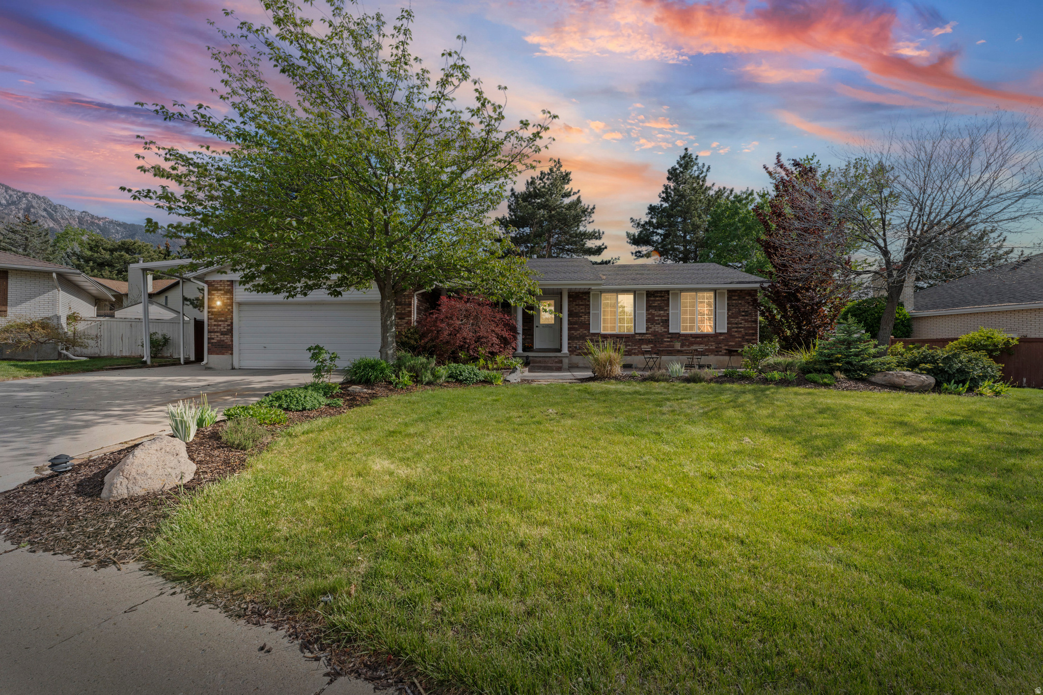 Tucked away in a quiet cul-de-sac in the heart of Sandy, just moments from Sego Lily Drive and Dimple Dell Park, this exceptional rambler offers the perfect blend of privacy, views, and thoughtful design. From the moment you arrive, you'll notice the peaceful setting, stunning mountain backdrop, and inviting curb appeal, complete with a charming front porch ideal for slow mornings and quiet evenings. Step inside and you're immediately greeted by an open, light-filled floor plan that feels both spacious and welcoming. The kitchen is the true centerpiece of the home, designed for those who appreciate both function and elevated finishes. Featuring double ovens, a Wolf gas cooktop, stainless steel appliances, an ice maker, tile flooring, a large granite island with bar seating, and extensive cabinetry, this space is built to perform and impress. The adjacent semi-formal dining area flows seamlessly, creating the perfect setting for hosting and everyday living. The family room is equally impressive, anchored by a stunning rock-accented gas fireplace with built-in shelving and surrounded by natural light. It's a space designed for connection, whether you're entertaining or simply enjoying a quiet night in. The main level includes a spacious primary suite with a walk-in closet and abundant natural light, along with a private en suite featuring tile flooring and a three-quarter shower. Two additional bedrooms offer comfortable space, while the full bathroom adds character with a classic clawfoot tub, pedestal sink, and updated finishes. A well-appointed laundry room with cabinetry and a folding station adds everyday convenience. Downstairs, the home continues to deliver with a large family room perfect for entertaining, relaxing, or creating a dedicated play space. A convenient kitchenette/wetbar with sink adds flexibility, while built-in shelving enhances both function and charm. Two additional bedrooms, a full bathroom, a versatile craft room or office, and an oversized utility room with extensive storage ensure there's space for everything. Don't miss the expansive cold storage area, a rare and valuable feature. Step outside and experience what truly sets this home apart. The backyard is designed for both relaxation and entertaining, featuring a covered patio, resealed concrete, and a built-in barbecue with its own bar and seating area. Whether hosting summer gatherings or enjoying a quiet evening, this space delivers. The yard offers ample room for kids and pets to play, along with garden boxes, a large shed, and generous RV parking with a covered carport, perfect for boats, trailers, or additional vehicles. Additional features include a water softener, built-in humidifier, and an active radon mitigation system for added peace of mind. Located in one of Sandy's most desirable areas, you'll enjoy quick access to Dimple Dell Park, shopping, dining, and major routes including 10600 South and 1300 East, all while being tucked away in a quiet, established neighborhood. This is a rare opportunity to own a home that truly checks every box. Schedule your private showing today. Buyer and Buyers agent to verify all information. Square footage figures are provided as a courtesy estimate only. Buyer is advised to obtain an independent measurement.
