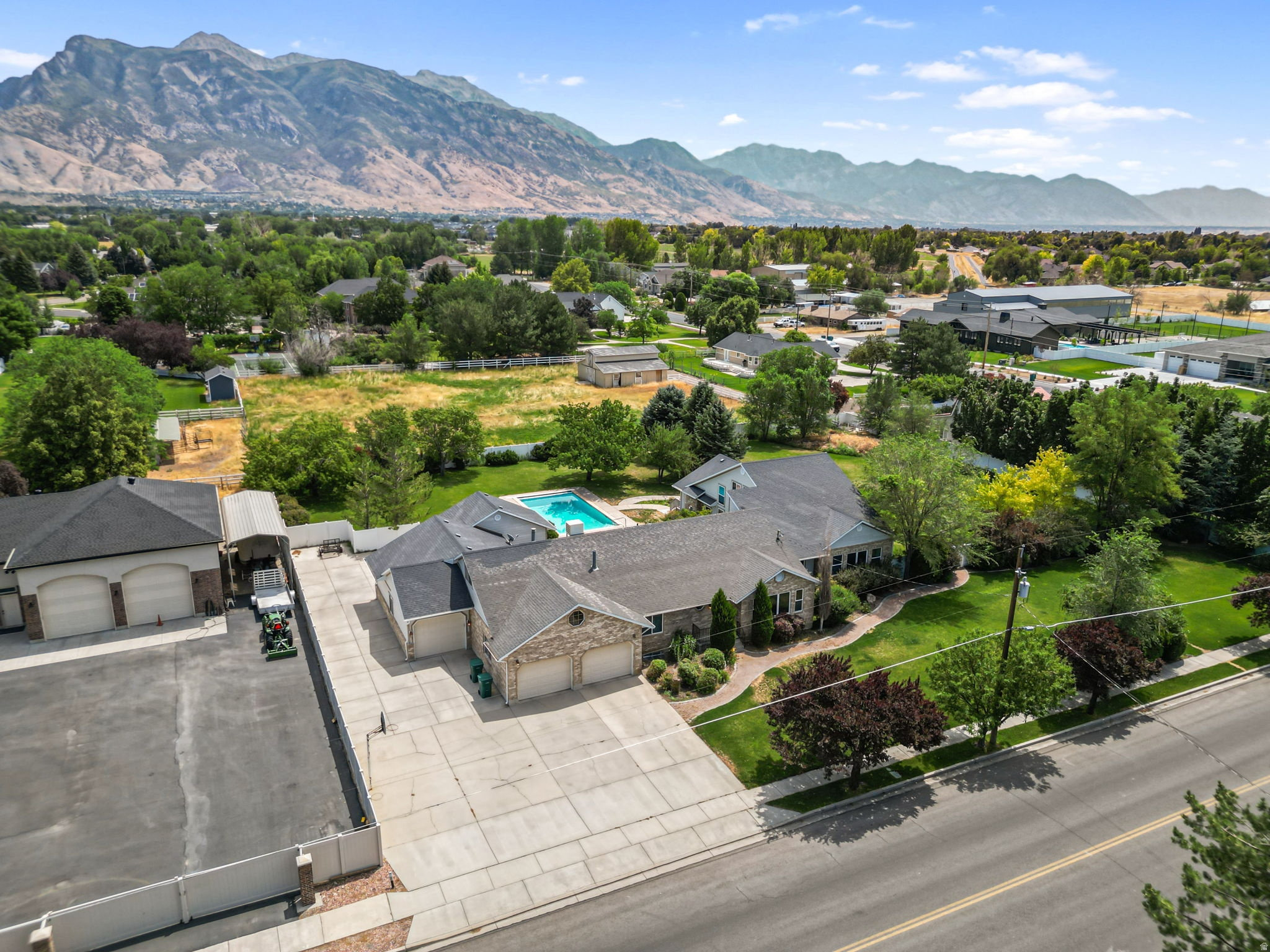 Hard-to-find Highland property with almost a full acre, horse/livestock zoning, and a 5-car garage. This lot gives you the space and flexibility that's missing in most homes nearby. The flat, fenced backyard includes fruit trees, mature landscaping, and a private in-ground heated pool with an electric cover. Inside, you'll find over 7,500 finished square feet with large gathering areas and great, functional living space. The updated addition features a main-level primary suite with a walk-in closet and jetted tub. Radiant floor heating with like-new boiler system ensures even consistent heating throughout the home. Additonally, the basement has a separate entrance and can be set up as a profitable ADU depending on how much personal space you want to keep for yourself. BRAND NEW ROOF replaced November 2025. Plenty of room for guests, trailers, animals, or whatever fits your lifestyle. To top it all off, the backyard views of Timpanogos and Mt Mahogany are to die for! Come and see for yourself!