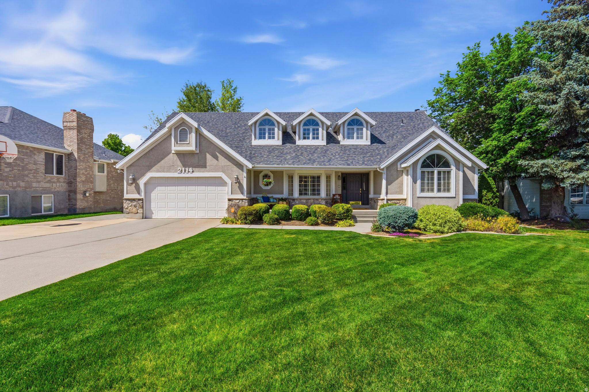 Tucked away on a quiet cul-de-sac, this stunning home sits on a beautifully landscaped HALF ACRE LOT surrounded by mature trees. The backyard is truly an oasis, featuring a FULLY FENCE POOL AREA, expansive PATIO space for hosting large gatherings, and an elevated DECK off the kitchen that creates seamless indoor-outdoor living. Inside, the home showcases an OPEN FLOOR PLAN with a large family room just off the beautiful, UPGRADED KITCHEN, creating the perfect gathering space. A front room with a vaulted ceiling, offers possibilities as a FORMAL LIVING ROOM OR HOME OFFICE.   You'll love the SPACIOUS PRIMARY SUITE complete with a BEDROOM SIZED WALK-IN CLOSET and a luxurious ENSUITE BATH featuring a separate tub and shower. (Primary Bedroom Closet could be restored as a 5th bedroom)  The walk-out basement adds incredible versatility with its own SECOND KITCHEN and laundry area, making it perfect for guests or multi-generational living. An oversized extra-length garage provides ample room for vehicles, storage, toys, or a workshop setup. Combining elegance, functionality, and resort-style amenities, this stunning home offers a rare opportunity in a highly desirable setting.  Centrally located in the Salt Lake Valley for an easy commute in all directions.
