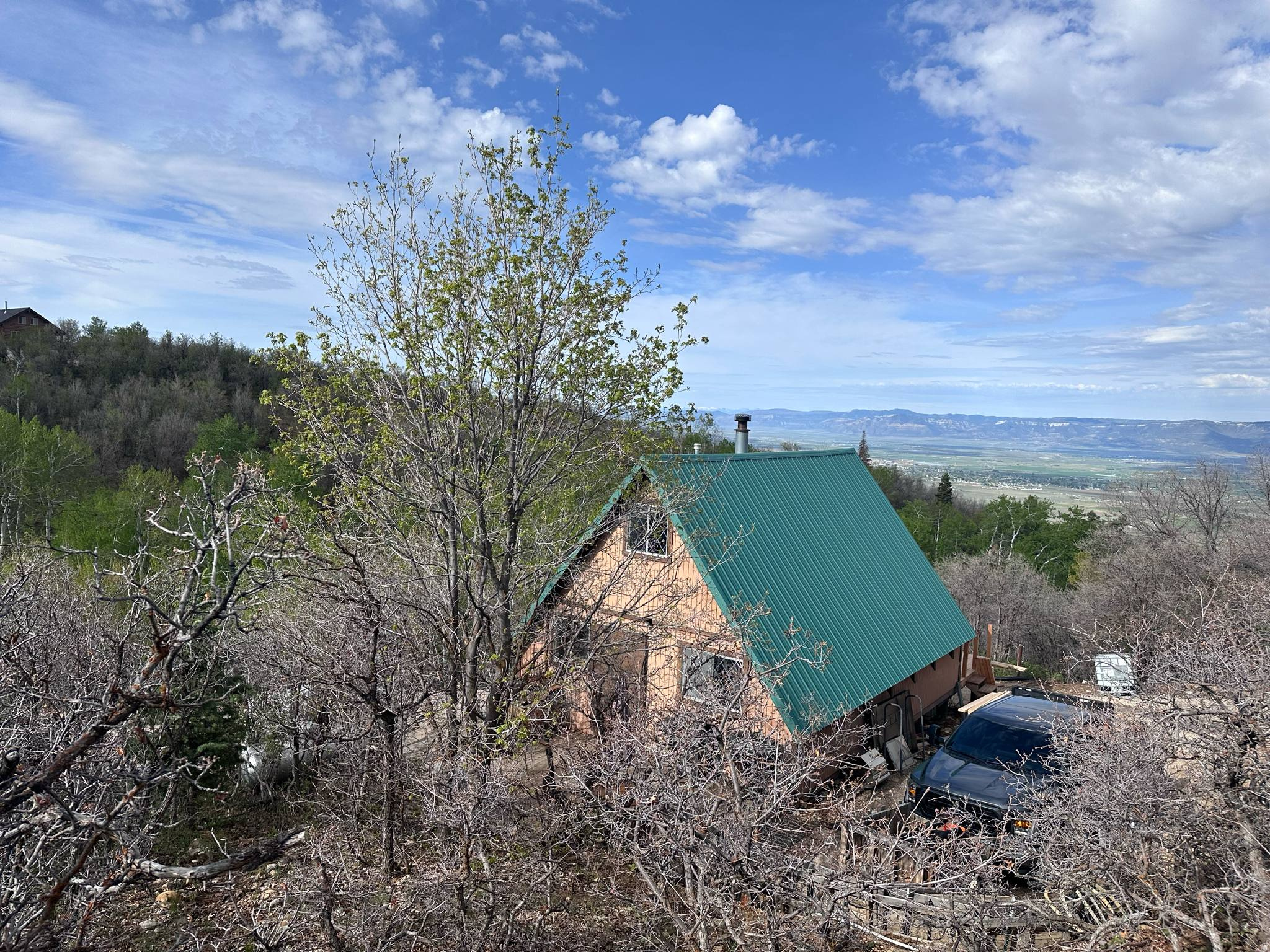 If the views from the front deck don't take your breath away, I don't know what will! Overlooking the valley, this cozy 2-bedroom, 1-bath off-grid cabin is the perfect place to unplug, relax, and enjoy everything mountain living has to offer.  Inside, you'll find an open family room and kitchen area centered around a warm wood-burning stove, creating the perfect gathering space after a day of adventure.  Designed for comfortable off-grid living, the cabin is powered by solar panels with a large battery bank, features a new water storage tank (water is hauled in or collected), and a septic system. The front deck has recently been rebuilt and freshly stained, giving you the perfect place to take in the incredible valley views. New windows and window trim are currently being installed, adding even more value and helping refresh the cabin's exterior.  Located on the main road within the gated Aspen Hills community, this property offers year-round access with a 4x4, as the HOA plows the main roads during the winter.  Aspen Hills is a beautiful recreational mountain community nestled in the foothills between Fairview and Mount Pleasant. With no public power or water, it offers the true mountain getaway so many people are searching for. Owners enjoy ATV riding, hiking, mountain biking, snowmobiling, camping, relaxing around warm fires, spending time at their cabins, and making memories with family and friends. Wildlife is abundant, and the peaceful mountain setting provides the perfect escape from the hustle of everyday life.  Whether you're looking for a weekend retreat, a basecamp for outdoor adventures, or simply a place to disconnect and recharge, this cabin is ready to welcome you.