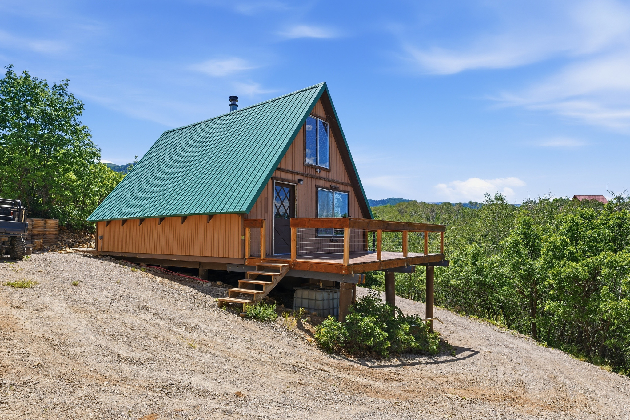 If the views from the front deck don't take your breath away, I don't know what will! Overlooking the valley, this cozy 2-bedroom, 1-bath off-grid cabin is the perfect place to unplug, relax, and enjoy everything mountain living has to offer.  Inside, you'll find an open family room and kitchen area centered around a warm wood-burning stove, creating the perfect gathering space after a day of adventure.  Designed for comfortable off-grid living, the cabin is powered by solar panels with a large battery bank, features a new water storage tank (water is hauled in or collected), and a septic system. The front deck has recently been rebuilt and freshly stained, giving you the perfect place to take in the incredible valley views. New windows and window trim are currently being installed, adding even more value and helping refresh the cabin's exterior.  Located on the main road within the gated Aspen Hills community, this property offers year-round access with a 4x4, as the HOA plows the main roads during the winter.  Aspen Hills is a beautiful recreational mountain community nestled in the foothills between Fairview and Mount Pleasant. With no public power or water, it offers the true mountain getaway so many people are searching for. Owners enjoy ATV riding, hiking, mountain biking, snowmobiling, camping, relaxing around warm fires, spending time at their cabins, and making memories with family and friends. Wildlife is abundant, and the peaceful mountain setting provides the perfect escape from the hustle of everyday life.  Whether you're looking for a weekend retreat, a basecamp for outdoor adventures, or simply a place to disconnect and recharge, this cabin is ready to welcome you.