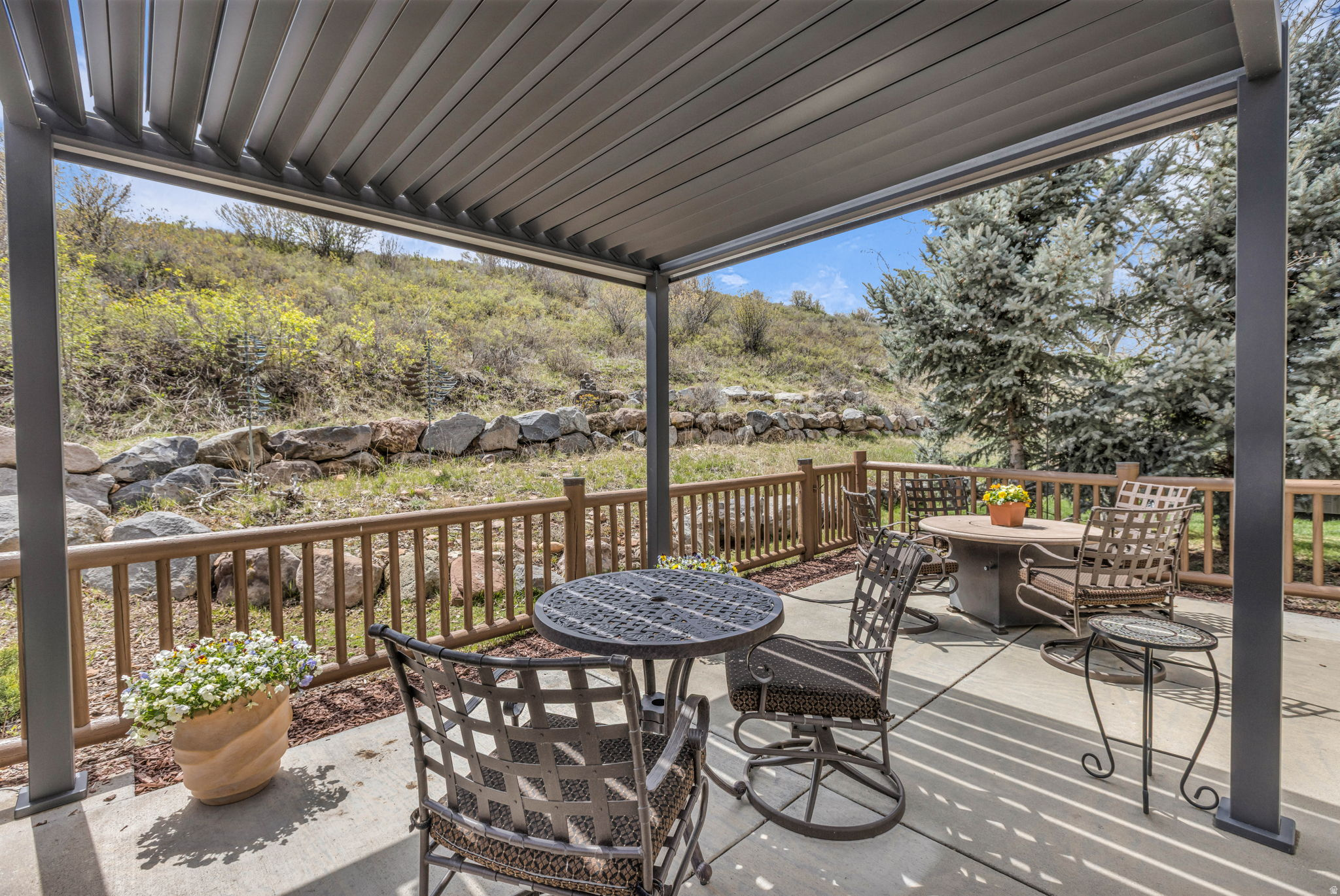 Light and Spacious End-Unit with Private Backyard. Beautiful Canyon Links townhome in desirable Jeremy Ranch, move-in ready and impeccably maintained. This spacious 4-bedroom, 3.5-bath home features a highly functional floor plan with two inviting outdoor living areas. The large fenced backyard patio with pergola is private and unique to the neighborhood. A front balcony off the main living area, complete with a high-end gas BBQ, offers lovely mountain views. The main level features an open-concept layout with a well-appointed kitchen, center island, abundant cabinetry and a generous living and dining area, anchored by a cozy gas fireplace. Hardwood flooring runs throughout most of the main floor, adding warmth and elegance. A convenient main-level ensuite bedroom provides flexibility for guests or single-level living. Upstairs, you'll find three additional bedrooms, including a comfortable primary suite. An upper-level alcove creates the perfect space for a home office or reading nook, with direct access to a private patio. Ample storage is available on every level of the home. The over-sized, two-car garage garage is heated with a built-in workbench, epoxy flooring and incredible storage. There is even a separate bike/ski storage room. This home is well-maintained and has several upgrades including washer/dryer 2022, microwave 2021, refrigerator and dishwasher, 2020. Backyard pergola with privacy/sun shades 2023. High speed internet is included in the HOA. Canyon Links is ideally located with quick access to I-80, Salt Lake City and Park City's world-class ski resorts, golf courses, mountain biking and hiking trails. This home is perfect as a primary residence, vacation home or investment property.  The two outdoor wind sculptures are excluded from sale.