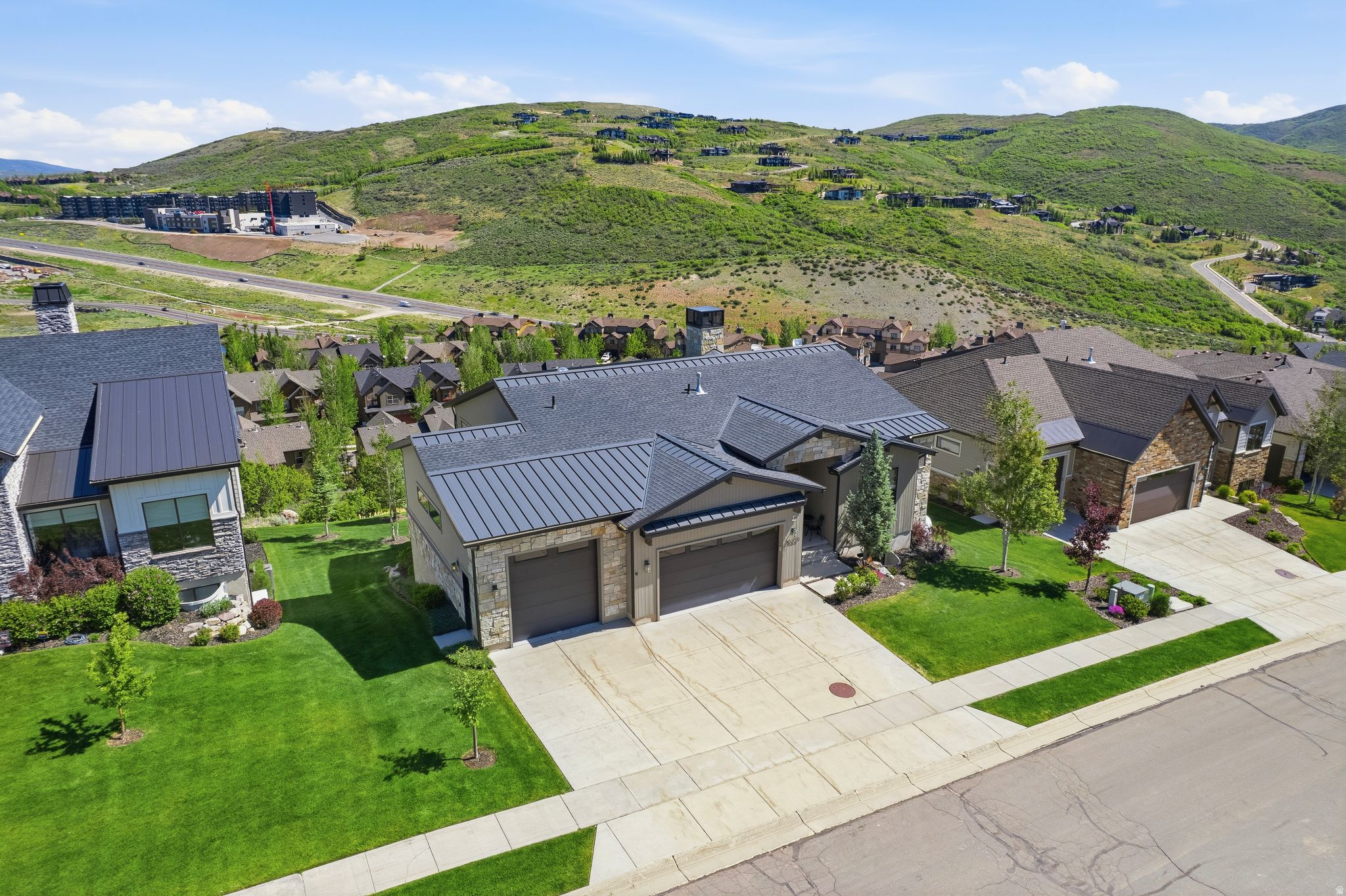 Experience mountain living at its finest in this exceptional mountain contemporary residence located at the end of a quiet cul-de-sac in The Retreat at Jordanelle. Perfectly positioned to capture expansive mountain and valley views while backing to open space, this beautifully designed home offers the ideal balance of privacy, luxury, and convenience. Thoughtfully crafted for effortless main-level living, the home features a spacious primary suite on the main floor, along with an additional ensuite guest bedroom, creating comfort and flexibility for owners and visitors alike. Soaring ceilings, exposed wood beams, custom cabinetry, wide-plank hardwood flooring, and walls of windows fill the home with natural light and showcase the surrounding mountain scenery. The heart of the home is an impressive great room anchored by a dramatic stone fireplace and seamlessly connected to a chef's kitchen featuring a large quartz island, professional-grade appliances, abundant storage, and designer finishes throughout. Multiple gathering spaces, including two separate family rooms and two fireplaces, provide ample room for entertaining, relaxing, and hosting family and friends. Outdoor living is equally impressive, with two covered outdoor spaces designed to maximize the mountain lifestyle. Enjoy morning coffee overlooking the valley, soak in the private hot tub after a day on the slopes, or gather around the custom fire pit patio under the stars. The lower level offers three additional bedrooms, creating comfortable accommodations for guests and multi-generational living. Additional highlights include a dedicated home office with inspiring views, a fitness room, spacious laundry room, oversized mudroom with custom built-ins, and an oversized three-car garage with extra height and depth for vehicles, outdoor gear, and recreational toys. Located just minutes from world-class recreation, you'll enjoy quick access to Deer Valley East Village, Park City Mountain, Jordanelle Reservoir, hiking and biking trails, and historic Main Street Park City. Salt Lake City International Airport is only approximately 30 minutes away, making weekend getaways and year-round living equally convenient. For buyers seeking investment flexibility, the property is located in an area that allows nightly rentals and has a strong rental history, making it an attractive option as both a luxury retreat and income-producing asset.    Square footage figures are provided as a courtesy estimate only and were obtained from appraisal .  Buyer is advised to obtain an independent measurement.
