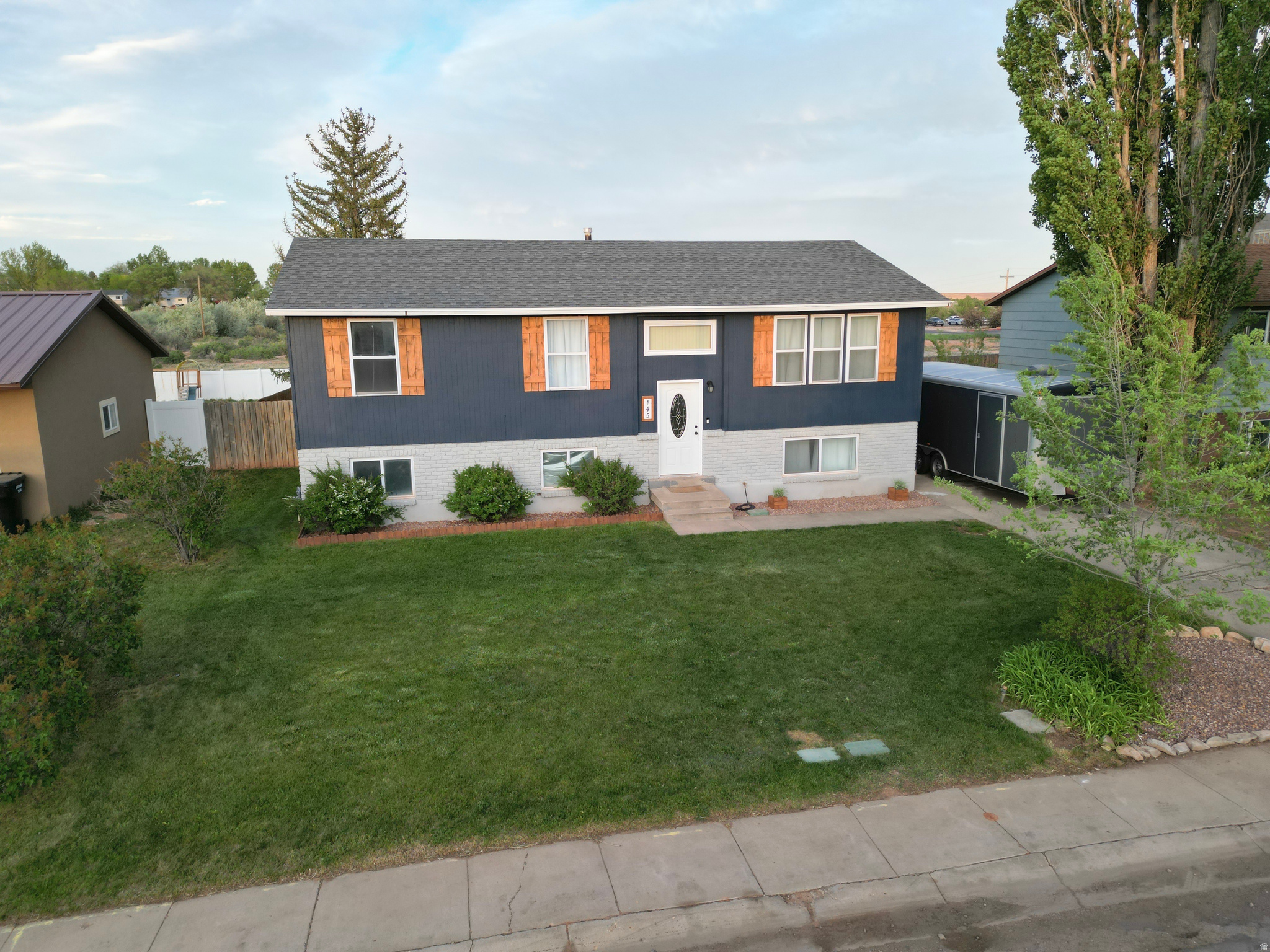 COME FALL IN LOVE with this beautifully updated 2,236 SF multi-level home situated on a spacious .24-acre lot! Featuring 5 bedrooms and 2 bathrooms, this inviting property offers room for everyone with stylish updates throughout. The recently remodeled kitchen shines alongside new LVP flooring and fresh carpet, creating a warm and welcoming feel. The exterior has been refreshed with new paint, charming shutters, and attractive landscaping that adds instant curb appeal. Step outside to enjoy the large deck off the kitchen and dining area - perfect for summer barbecues, entertaining guests, or simply relaxing outdoors. The fenced backyard features a storage shed, beautifully landscaped grounds, and automatic sprinkler systems in both the front and back yards for easy maintenance and enjoyable outdoor living. Don't miss your opportunity to own this move-in ready home that blends comfort, style, and functionality! Square footage figures are provided as a courtesy estimate only and were obtained from county records. Buyer is advised to obtain an independent measurement.