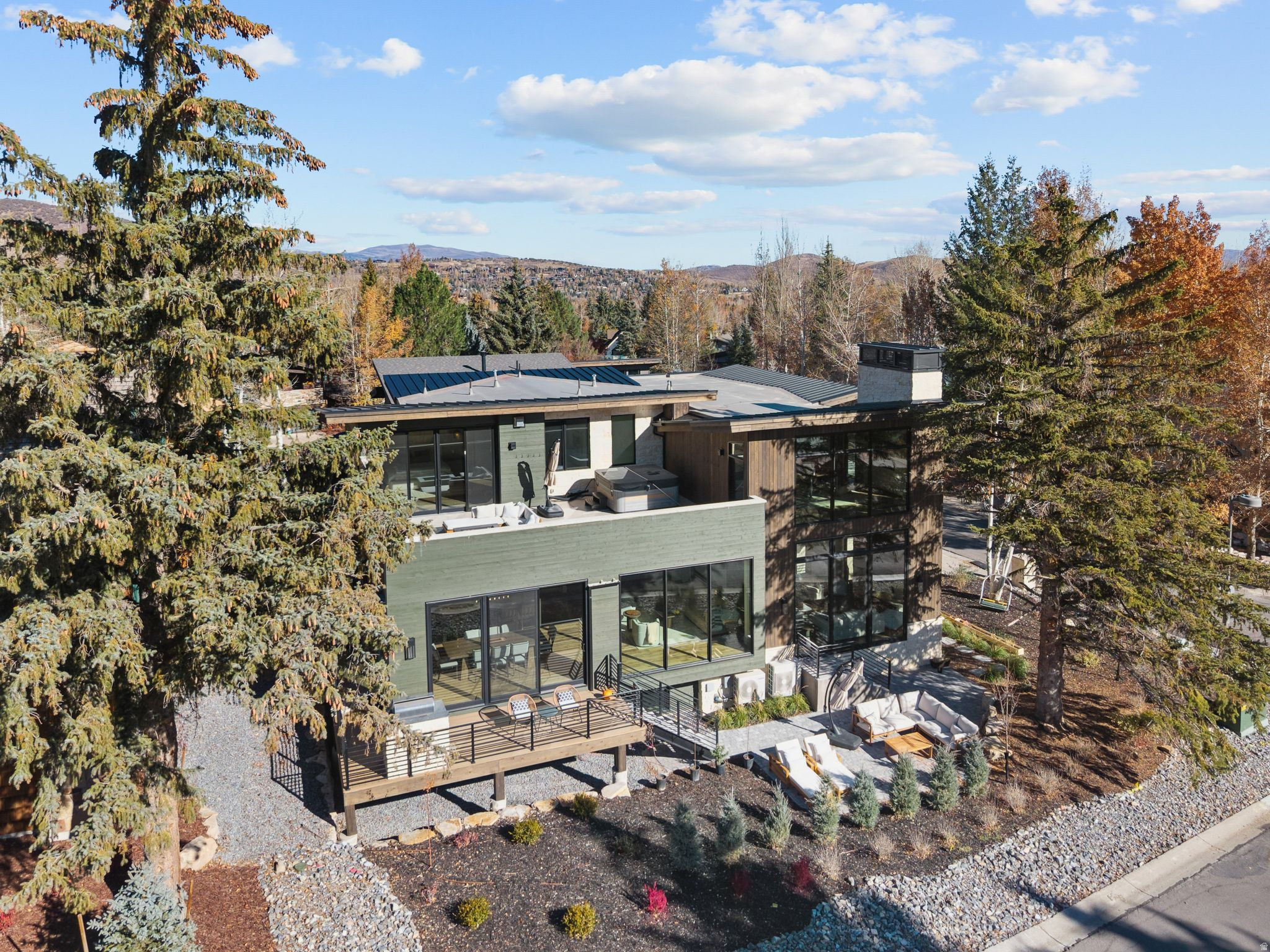 This brand new constructed home in Thaynes Canyon offers the rare combination of privacy, proximity, and prestige. Set on a corner lot in one of Park City's most beloved neighborhoods, this home is walking distance to resort lifts, Silver Star Cafe, golfing, and grocery stores.  Every inch of this residence has been designed with the highest level of craftsmanship and attention to detail. With hardwood floors and radiant heating, full stone walls, natural barn wood accents, and a hand-made chandelier from local glass artisans.  A chef's kitchen blends modern design with warm mountain elements. An oversized waterfall island, hidden butler's pantry, and top of the line appliances including a built in coffee maker and steam oven, make this kitchen both stunning and functional. Walls of glass flood the dining and living spaces with natural light, framing postcard views of snow-capped peaks and open meadows from every room.  The top floor features an oversized primary suite and an 800 sqft rooftop deck with a hot tub. With unobstructed views from the bed, not only can you view the stars over the open meadows, but watch the snowcats hard at work getting ready for your next ski day. The sprawling bathroom includes a freestanding tub, triple head waterfall shower, and a dream walk-in closet with built-in laundry.  Working becomes a pleasure in an idyllic glass walled office with a stone fireplace and epic resort views, while wellness and recreation are built into the home's design with a large gym, steam room, and dry sauna featuring an illuminated Pakistani Himalayan salt wall.  A sunken theater with 15-foot ceilings offers a flexible space for entertainment. The custom ski room with waxing station and boot dryers ensures you're ready for the short walk to the lifts, while the tall three-car garage  offers ample space for wheels and toys of any kind.   Move-in ready and unmatched in its category, this is a true unicorn property and a statement of refined taste.