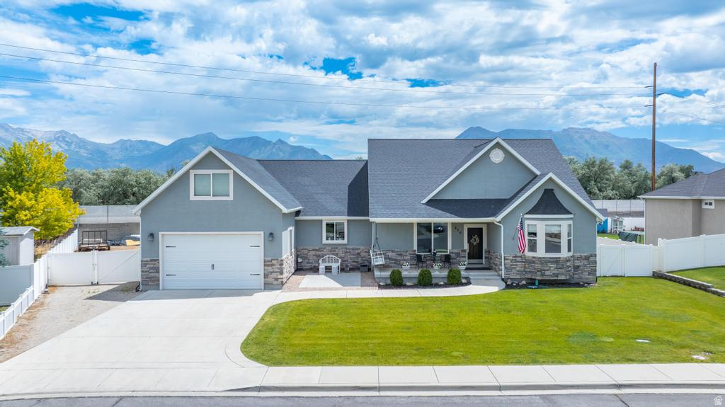 Beautiful Custom Rambler in quiet Lehi community. Built and owned by a developer with quality and comfort in mind. This home offers an open floor plan and tons of natural light. Custom features include 2 primary suites, a walk-in shower, wood floors throughout, a gourmet kitchen with double ovens, an over-sized island with built-in bar, and large adjoining dining area perfect for hosting and gathering. Step outside to enjoy the wrap around deck with built-in hot tub, ideal for entertaining or a peaceful evening to yourself. You'll also love the huge fully fenced yard featuring a 20' W x 36' L x 15' H Metal Storage Building (3 sided/open front) with tons of space to park and store toys, trailers, an RV, and more. Incredible home. Awesome neighbors. Schedule your private showing today.