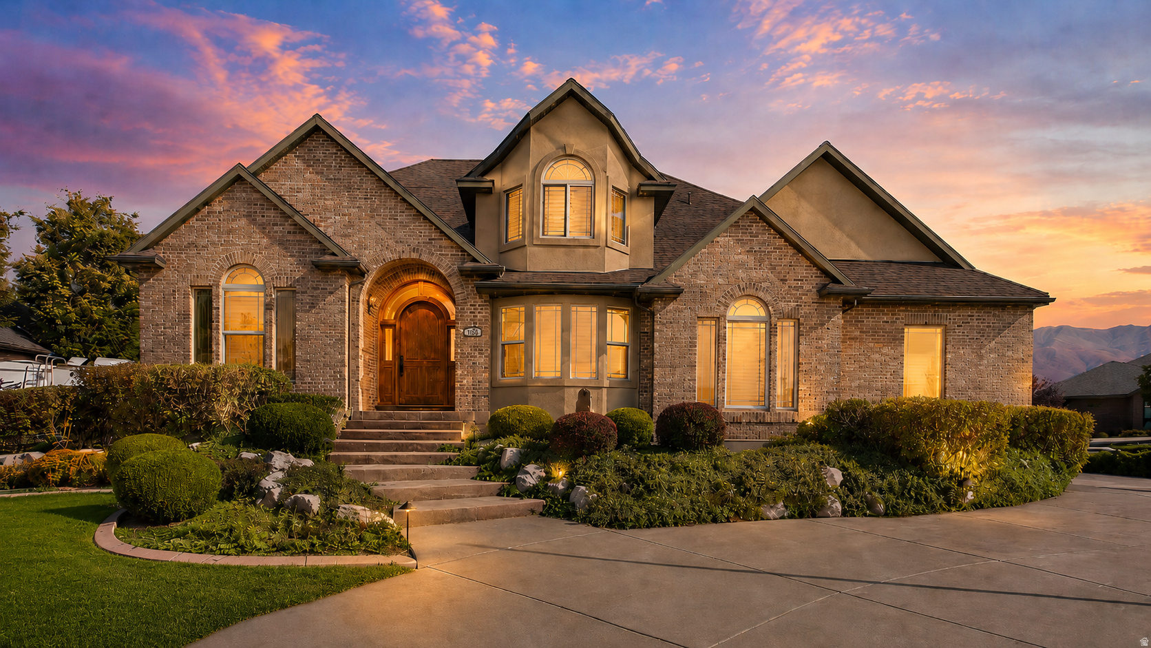 Custom Kaysville home on nearly an acre in a quiet cul-de-sac with equestrian appeal, mountain and sunset views, and resort-style outdoor living. The bright, open floor plan features rich wood finishes, vaulted ceilings, smart home lighting/audio with speakers throughout, and a fully finished walkout basement with second kitchen. Enjoy the in-ground pool, spa, waterfall, covered patio, theater room, exercise space, 4-car garage, RV parking, and abundant storage. Easy access to West Davis Highway offers a convenient route to Salt Lake City International Airport, Utah ski resorts, and canyon recreation. A rare blend of privacy, amenities, and location.