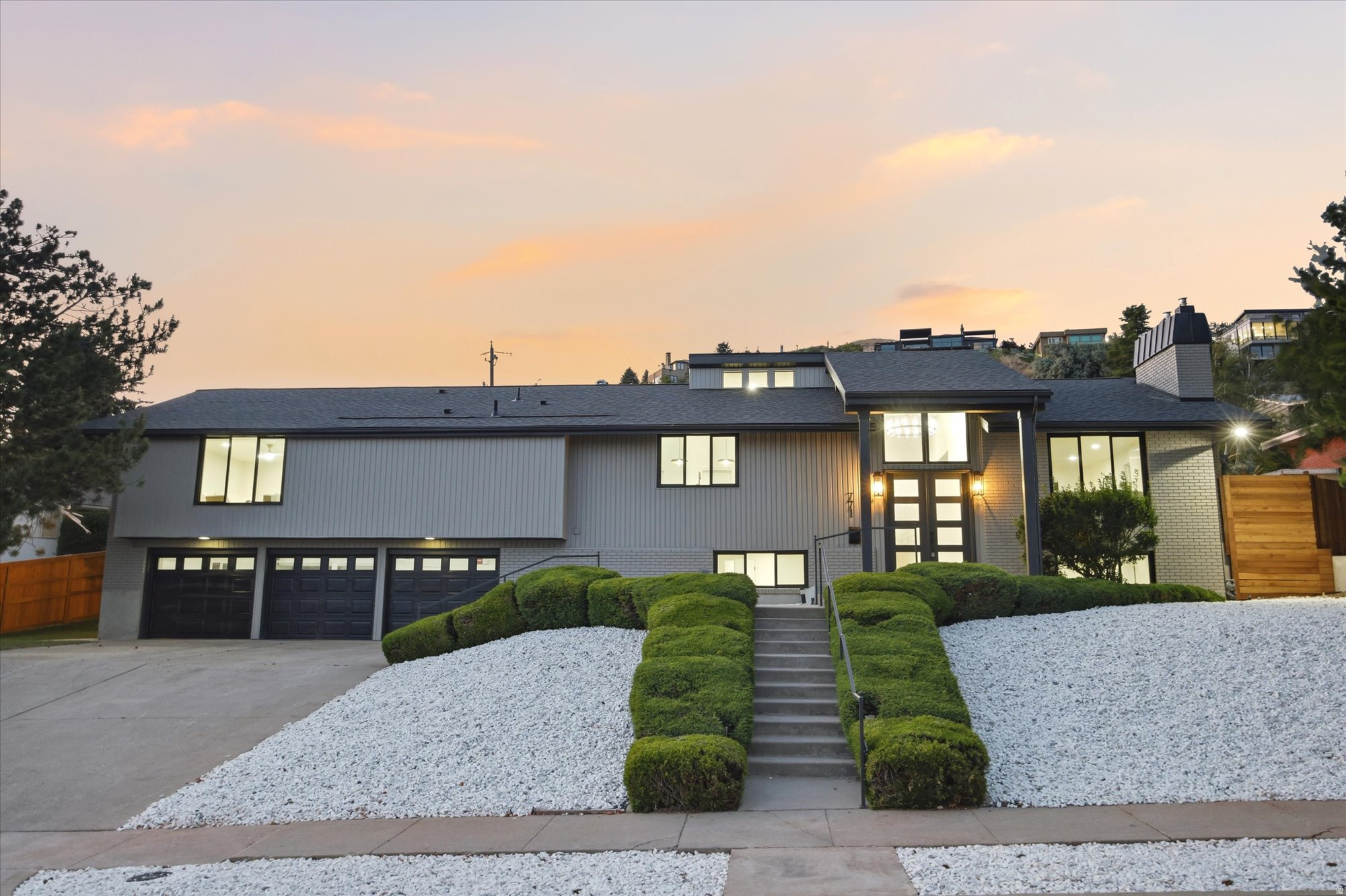 Perched high in Salt Lake City's coveted Upper Avenues, this beautifully reimagined Mid-Century Modern residence combines timeless architecture with elevated modern living. Designed to embrace its desirable south-facing orientation, expansive picture windows along the front of the home showcase breathtaking views of the Salt Lake Valley, downtown skyline, the State Capitol, and the surrounding Wasatch Mountains while filling the interior with natural light throughout the day.  The heart of the home is a stunning gourmet kitchen featuring a 48" gas range, custom vent hood, designer finishes, and an impressive butler's pantry that offers exceptional storage and preparation space. Flowing seamlessly into the dining and living areas, the main level is perfectly designed for both entertaining and everyday living, anchored by a beautiful fireplace and framed by the home's incredible views.  The luxurious primary suite offers a true retreat with a spa-inspired ensuite featuring a freestanding soaking tub, oversized rainfall shower, dual vanities, and a spacious walk-in closet. Three bedrooms are located on the main level, while the lower level offers two additional bedrooms, a second family room, and flexible living space ideal for guests, multigenerational living, or a home office. Laundry on both levels provide exceptional convenience.  Located just moments from the Bonneville Shoreline Trail, nearby foothill recreation, the University of Utah, downtown Salt Lake City, and some of the area's most beloved neighborhood amenities, this is a rare opportunity to own a thoughtfully renovated home in one of Salt Lake City's most prestigious and enduring neighborhoods.    Square footage figures are provided as a courtesy estimate only and were obtained from county records .  Buyer is advised to obtain an independent measurement.