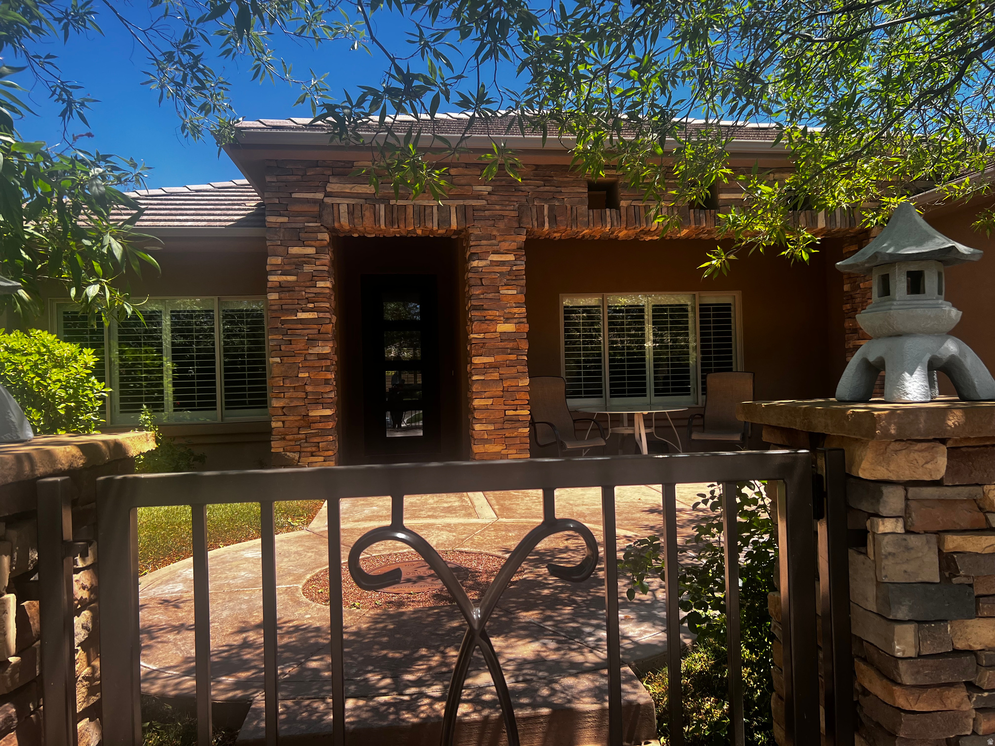 Priced WELL BELOW CURRENT APPRAISAL. Welcome to this beautifully designed desert retreat where timeless craftsmanship meets relaxed luxury living. From the moment you arrive, the striking stacked-stone exterior, secluded courtyard entry, and iron entry door create an unforgettable first impression. The home boasts coffered ceilings, abundant natural light, and 'plank look' tile throughout. Plantation shutters on oversized windows that frame the living spaces. The spacious living and dining areas blend warmth and sophistication with rich wood tones, curated lighting, and inviting gathering spaces. The luxuriously designed primary suite offers comfort, privacy, and effortless living, while the indoor-outdoor connection makes this home ideal for both quiet mornings and evening entertaining.
