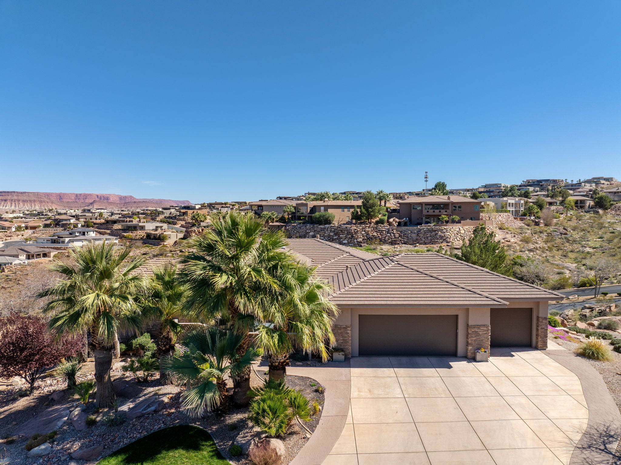 Welcome to this stunning home in the highly sought-after Stone Cliff community, offering breathtaking mountain views and exceptional indoor-outdoor living. Situated on a spacious .49 acre lot, this property features a bright open floorplan designed for comfort and entertaining. The gourmet kitchen showcases beautiful knotty alder cabinetry, granite countertops, a walk-in pantry, and generous counter space. Thoughtful upgrades throughout the home include a movie theatre, zoned HVAC for efficiency, built-in audio and an impressive primary en-suite. Step outside to your private backyard retreat featuring two expansive decks, an outdoor fireplace, hot tub, tranquil waterfall, and full irrigation, all perfectly positioned to take in the surrounding mountain views. Residents of Stone Cliff enjoy resort-style amenities with a guard-gated entrance, and an active clubhouse hosting events throughout the year. The HOA provides access to a fitness center, pools, pickleball courts, tennis courts, and bocce ball courts, creating a vibrant and welcoming community. Conveniently located near shopping, dining, and everyday conveniences.