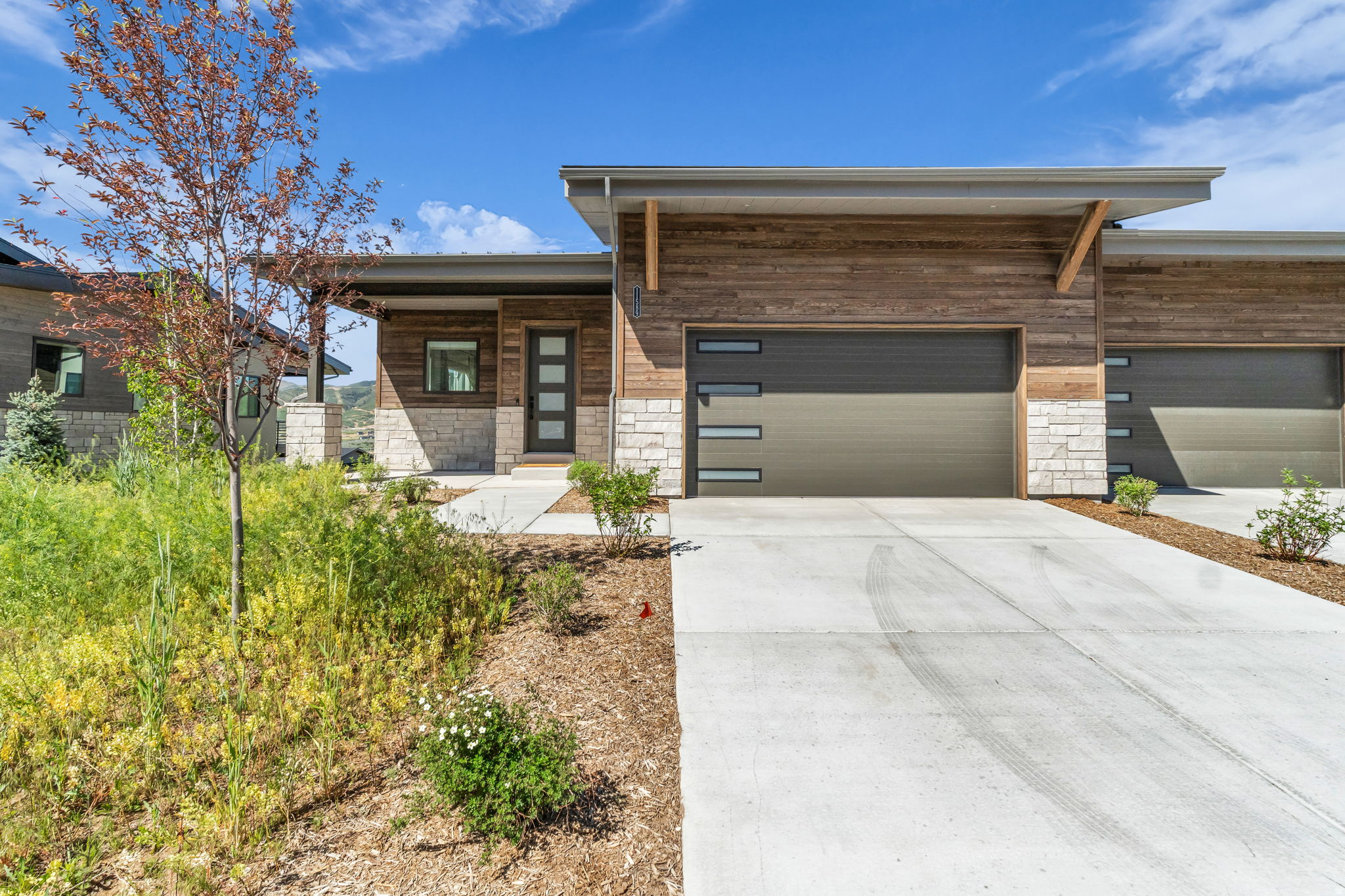 Experience elevated mountain living in this exceptional Shoreline twin home, perfectly positioned to capture permanently unobstructed views of Deer Valley East Village and Jordanelle Reservoir. This Outlook Model offers 3,230 square feet, three bedrooms, three-and-a-half baths, and an impressive collection of builder upgrades, this turnkey residence delivers luxury, comfort, and lock-and-leave convenience in one of Hideout's most sought-after communities.  Designed to maximize both natural light and the spectacular surroundings, the open-concept main level features expansive windows that showcase panoramic mountain and lake views from nearly every room. Wide-plank hardwood floors, designer finishes, electric blinds, and the builder's largest gas fireplace create a warm, sophisticated living space that is equally suited for entertaining or quiet evenings at home.  Step outside to the heated covered deck and enjoy seamless indoor-outdoor living throughout every season. Whether watching the sunrise over Deer Valley with your morning coffee or soaking beneath the stars in the private Bullfrog spa after a day on the slopes, every space has been thoughtfully designed to embrace the surrounding landscape.  The lower level offers a dedicated theater room, creating the perfect retreat for movie nights, sporting events, or hosting family and friends along with two queen size murphy beds.  The epoxy-finished garage is equally impressive, featuring custom cabinetry, built-in organization, and abundant storage for skis, bikes, paddleboards, and all of your mountain gear.  Located just minutes from Deer Valley East Village, Jordanelle Reservoir, championship golf, miles of hiking and biking trails, and Historic Main Street Park City, this residence places year-round adventure right outside your door while offering the ease of low-maintenance mountain living. With premium upgrades, exceptional craftsmanship, and some of the finest protected views in the area, this is a rare opportunity to own one of Shoreline's premier homes.
