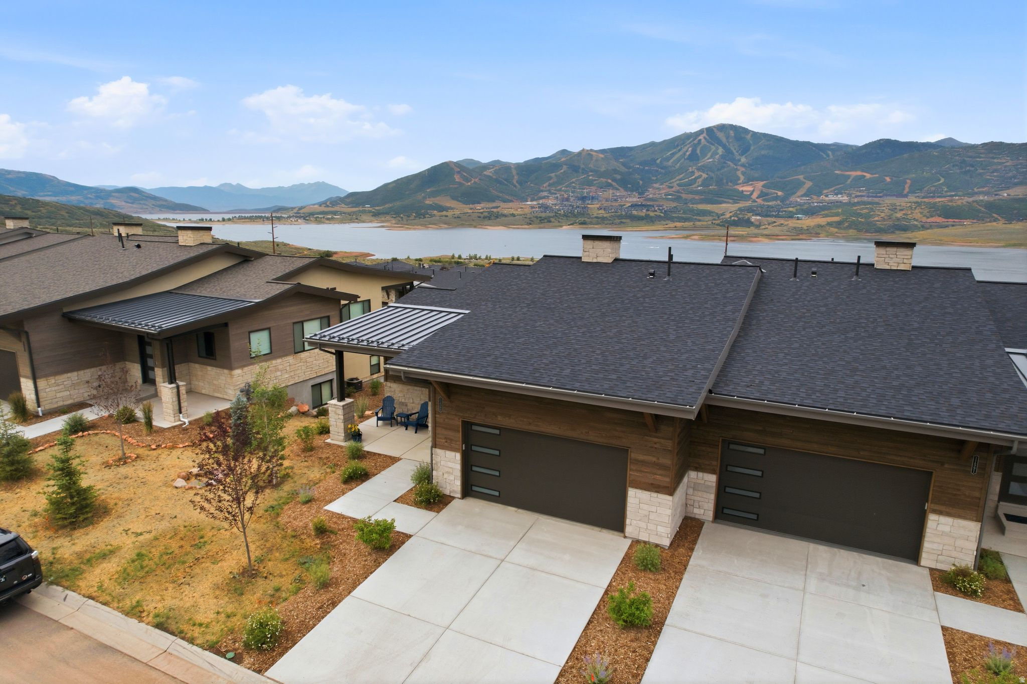 Experience elevated mountain living in this exceptional Shoreline twin home, perfectly positioned to capture permanently unobstructed views of Deer Valley East Village and Jordanelle Reservoir. This Outlook Model offers 3,230 square feet, three bedrooms, three-and-a-half baths, and an impressive collection of builder upgrades, this turnkey residence delivers luxury, comfort, and lock-and-leave convenience in one of Hideout's most sought-after communities.  Designed to maximize both natural light and the spectacular surroundings, the open-concept main level features expansive windows that showcase panoramic mountain and lake views from nearly every room. Wide-plank hardwood floors, designer finishes, electric blinds, and the builder's largest gas fireplace create a warm, sophisticated living space that is equally suited for entertaining or quiet evenings at home.  Step outside to the heated covered deck and enjoy seamless indoor-outdoor living throughout every season. Whether watching the sunrise over Deer Valley with your morning coffee or soaking beneath the stars in the private Bullfrog spa after a day on the slopes, every space has been thoughtfully designed to embrace the surrounding landscape.  The lower level offers a dedicated family room, creating the perfect retreat for movie nights, sporting events, or hosting family and friends along with two queen size murphy beds, a flex room and a bar with a beverage/wine cooler. The garage is equally impressive, featuring  built-in organization, and abundant storage for skis, bikes, paddleboards, and all of your mountain gear.  Located just minutes from Deer Valley East Village, Jordanelle Reservoir, championship golf, miles of hiking and biking trails, and Historic Main Street Park City, this residence places year-round adventure right outside your door while offering the ease of low-maintenance mountain living. With premium upgrades, exceptional craftsmanship, and some of the finest protected views in the area, this is a rare opportunity to own one of Shoreline's premier homes.