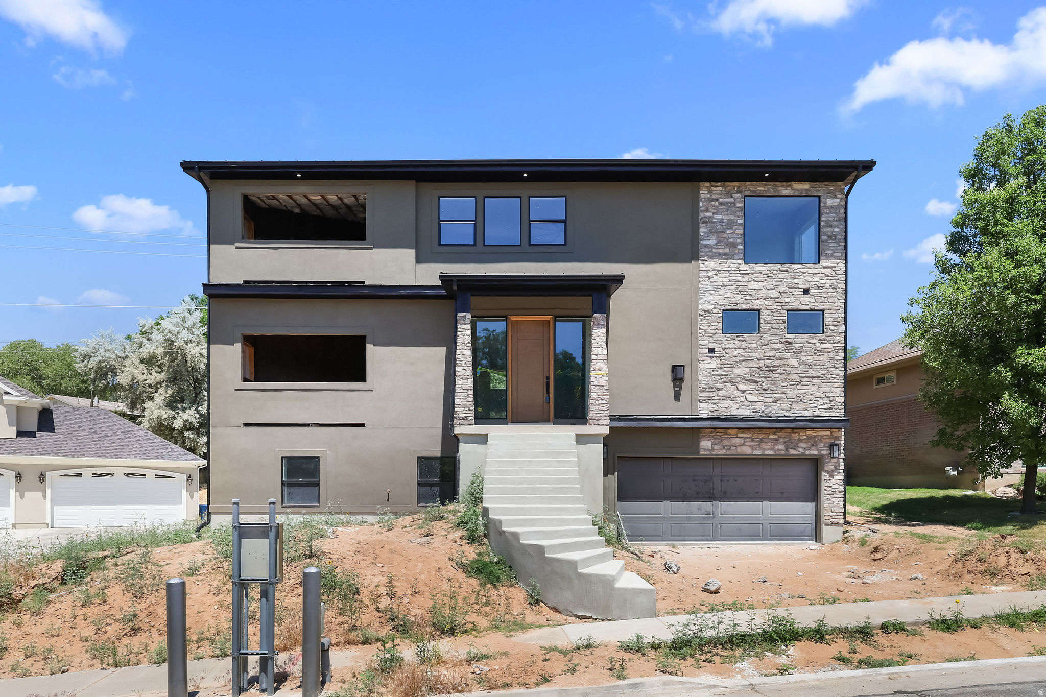 Modern luxury is taking shape in South Ogden! This under-construction custom 2-story home offers a bright, open design with elevated ceilings on every level and incredible indoor/outdoor living.  The main level features 10' ceilings, a stunning great room with fireplace, and a modern layout filled with natural light. Upstairs, the oversized MASTER SUITE is A TRUE RETREAT with dramatic 8' - 15' ceiling, its own fireplace, and access to elevated outdoor living. Two patios with fireplaces create cozy spaces to unwind, entertain, and enjoy the mountain lifestyle.  The basement offers 9' ceilings and a built-in ADU with a separate heating and cooling system, adding flexibility for guests, extended family, or investment potential.  Located in South Ogden with easy access to the great outdoors, this home is less than 30 minutes from Snowbasin Ski Resort and Wasatch Peaks Ranch (skiing & golfing). Within 3 minutes of the Ogden Golf & Country Club!    Modern comfort, lifestyle, and ADU attached.   Square footage figures are provided as a courtesy estimate only and were obtained from builder plans.    Buyer is advised to obtain an independent measurement.