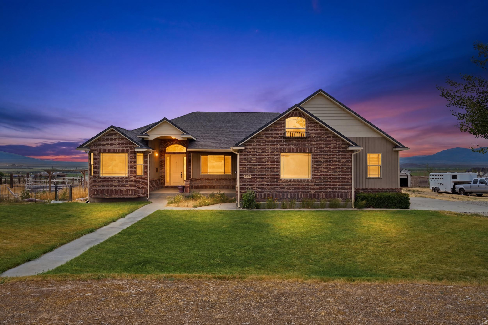Luxury living without the luxury price tag. Set on 1.10 acres offering privacy and land to spread out, this rambler is built for main-level living with room to grow. The primary suite anchors the main floor with a walk-in closet, double sinks, and a stand-up double shower paired with a relaxing jetted tub. Just inside, a formal living room doubles as the perfect home office or remote workspace, flowing into an open-concept great room, kitchen, and dining area built for gathering - abundant counter space and rich wood cabinetry throughout. Three bedrooms and a full laundry room with its own sink and storage cabinets complete the main level, while upstairs, a fourth bedroom with an attached spare room offers flexible space for a guest suite, playroom, or private retreat. Downstairs, a full basement awaits your vision, already featuring a gas range, a partially finished bathroom, and a partially drywalled bedroom, ready to be finished your way. A bonus propane-powered backup generator is already hooked up and ready when needed, and the seller added a propane gas stove and oven in the basement - ready for you to make it a second kitchen. A propane gas line was also installed for converting the kitchen and fireplace to gas. This property is perfect for horses, with room to roam and easy access for relaxing evening rides, plus easy and quick access to public lands within minutes. Unwind on one of two oversized back decks and take in magical views as the sun sets. Rare luxury touches include radiant heated flooring throughout, a hot water recirculation system, dual 50-gallon water heaters, a wood-burning stove, and a standby generator. Updated roof and high-efficiency A/C round out the package. Space, privacy, land, and a little of everything - this one has it all. Square footage figures are provided as a courtesy estimate only and were obtained from Tax Records.  Buyer is advised to obtain an independent measurement.