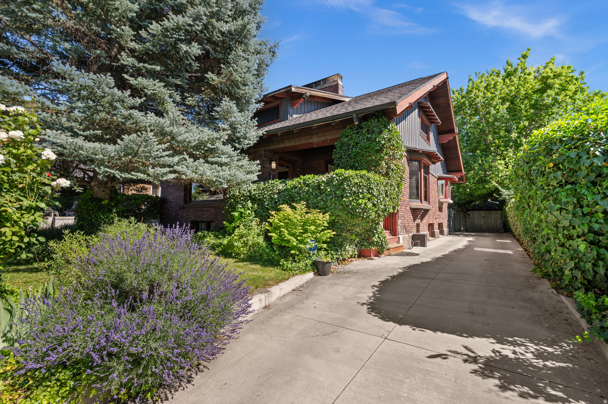 Magnificent bungalow filled with charm and timeless craftsmanship. Originally custom-built for a prominent Salt Lake family, this special home has been lovingly cared for through generations of owners who have preserved its remarkable architectural details. Beautiful original woodwork, exposed beams, and rich Craftsman details remain intact throughout. Memorable features include the stunning library/pass-through with fireplace- something rarely found. The large dining room is simply amazing with a built-in buffet and another fireplace.  The lower level features high ceilings and functions beautifully as a separate living unit, guest quarters, or can easily be incorporated into the main residence for additional living space. Above, the unfinished attic offers over 400 square feet with generous ceiling height and existing windows-an incredible opportunity for future expansion. Gorgeous backyard surrounded by mature landscaping and lush greenery- a private retreat. Alley access provides convenient entry to the garage along with additional off-street parking. This one is a stunner!