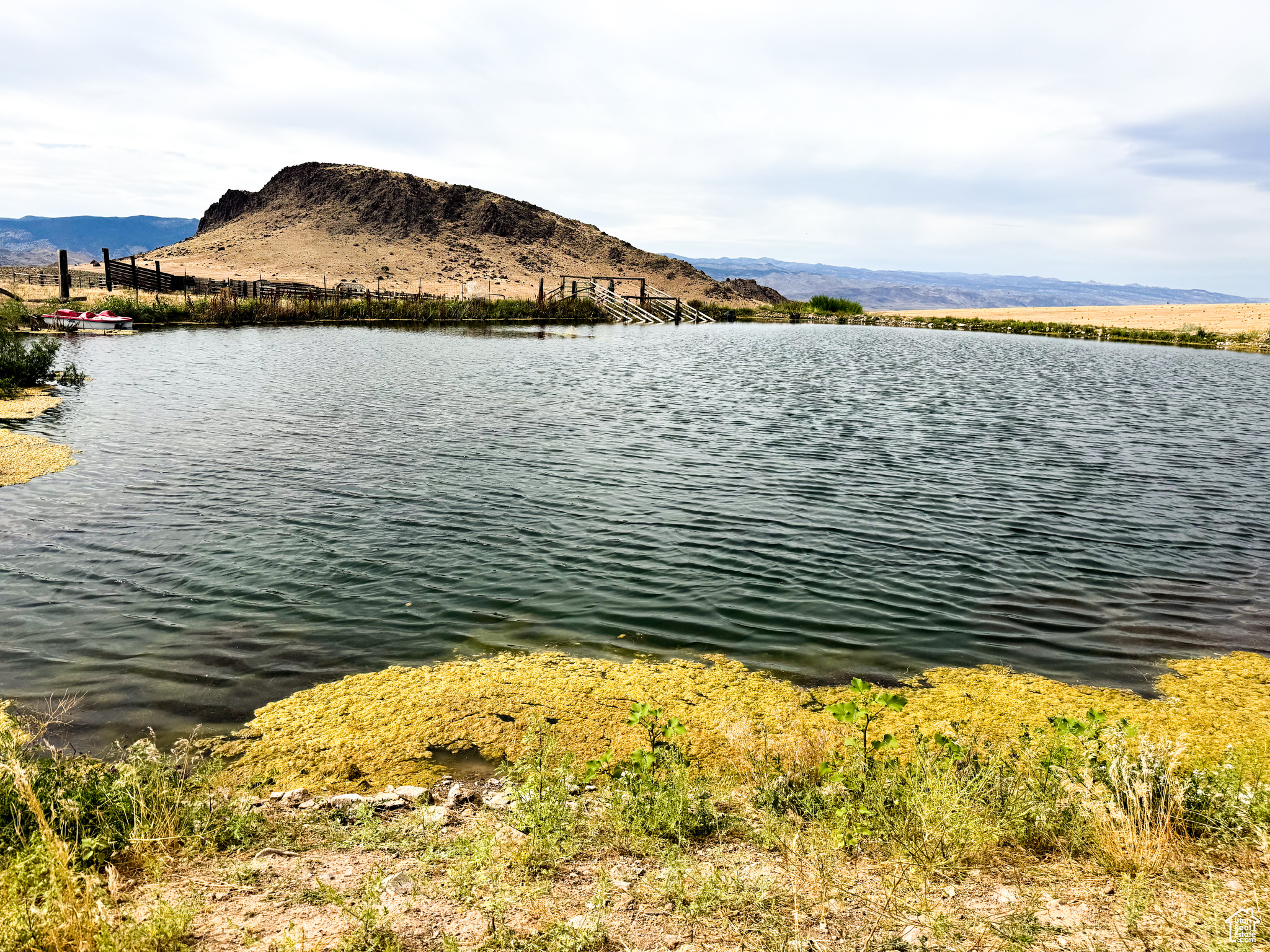 Welcome to a rare opportunity to own 198 acres of pristine land in Monroe, Utah. This exceptional property includes a fishing pond, three versatile outbuildings, and 70 acres currently under cultivation with grass and alfalfa - making it ideal for farming, ranching, or creating your private retreat. Irrigation water associated with water rights 63-9 and 63-3139. Survey measurement from 2013 indicates approximate flow equivalent to ~52.27 shares; buyer to verify with irrigation company. A pivot included, the land is well-suited for farming, ranching, or simply enjoying wide-open space. Power is provided by a generator which is included. The property features three outbuildings that provide ample room for storage or equipment, along with a pond stocked with fish-perfect for relaxing days spent outdoors with family and friends. Whether you're seeking a family getaway, an agricultural retreat, or a private sanctuary surrounded by nature, this property delivers unmatched beauty and seclusion.