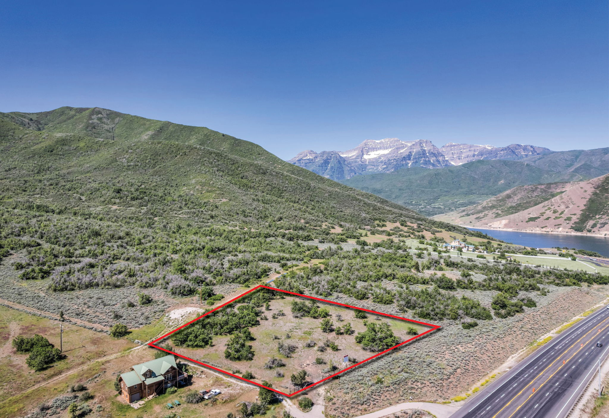 Perched above Deer Creek Reservoir on approximately 2.13 acres, this exceptional estate parcel offers commanding panoramic views of Mount Timpanogos, the sparkling reservoir below, and the surrounding Wasatch Mountain range. Set among other premier acreage estates, the property presents a rare opportunity to create a private custom retreat in one of the most breathtaking and sought-after settings. The gently sloping homesite provides outstanding flexibility for architectural design, allowing for expansive indoor-outdoor living, large view corridors, and seamless integration with the surrounding landscape. Whether envisioning a modern mountain residence, luxury getaway, or legacy estate, the property offers the ideal backdrop for a home centered around privacy, tranquility, and year-round recreation.  Outdoor adventure begins just moments from your future doorstep. Launch your boat across the street at Deer Creek Reservoir, enjoy world-class fishing, paddleboarding, hiking, biking, or simply take in the serenity and beauty that make this area so special. The combination of open space, dramatic scenery, and peaceful surroundings creates a lifestyle that is increasingly rare to find along the Deer Creek corridor.  Despite its quiet and secluded atmosphere, the property remains conveniently located just 15 minutes from Sundance Mountain Resort, approximately 20 minutes to Utah County, and only minutes to the Heber Valley for dining, golf, shopping, and everyday amenities. Parcels with this level of privacy, usability, and unobstructed reservoir and mountain views are becoming increasingly difficult to secure.