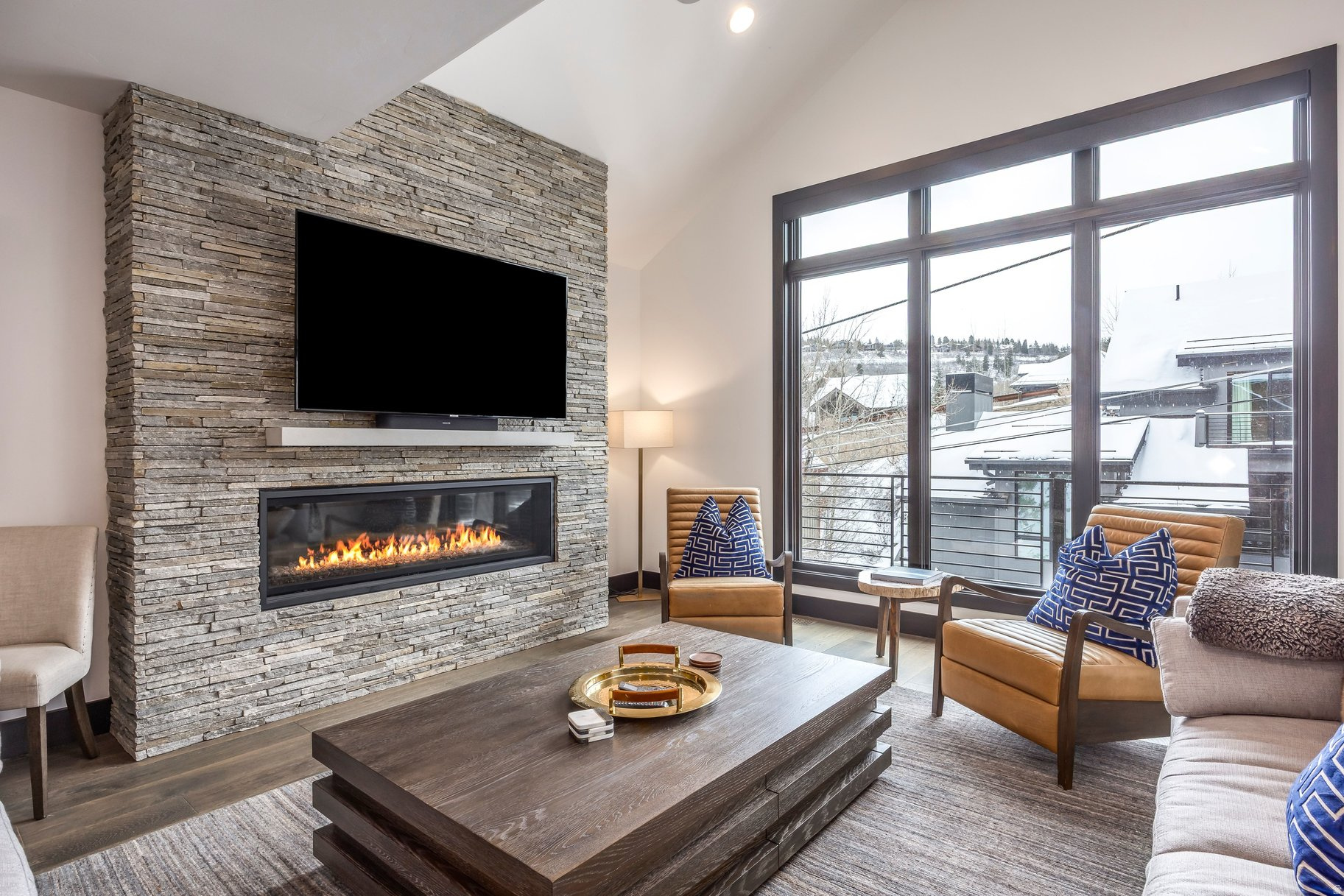 This exceptional contemporary residence offers a refined blend of modern design and elevated mountain living. Spanning approximately 4,600 square feet, the home showcases uncompromising craftsmanship, thoughtful detailing, and a highly livable floorplan designed for both comfort and entertaining with indoor and outdoor living. The residence accommodates up to 12 guests with four private ensuite bedrooms and a custom-designed bunk room, creating the ideal retreat for family and friends. Over 1,000 square feet of heated outdoor living space invites year-round enjoyment, seamlessly extending the interiors into inviting outdoor gathering areas. Four levels are easily accessed via private elevator and include a media lounge, billiards/game room, and generous storage. A two-car garage is complemented by two additional covered parking spaces - a rare and valuable amenity in Old Town. Exquisite finishes elevate every space, including solid white oak flooring, dramatic stacked-stone fireplaces, professional-grade Viking appliances, and designer fixtures by Kohler, Brizo, and Hansgrohe. The home is offered fully furnished with curated, high-end furnishings for immediate enjoyment. Just steps from the Quit 'N Time ski run at Park City Mountain Resort and a short stroll to Historic Main Street, this extraordinary property provides effortless access to world-class skiing, dining, shopping, hiking, and biking trails. Located only 35 minutes from Salt Lake City International Airport, it offers a rare combination of convenience, luxury, and one of Old Town's most desirable settings.