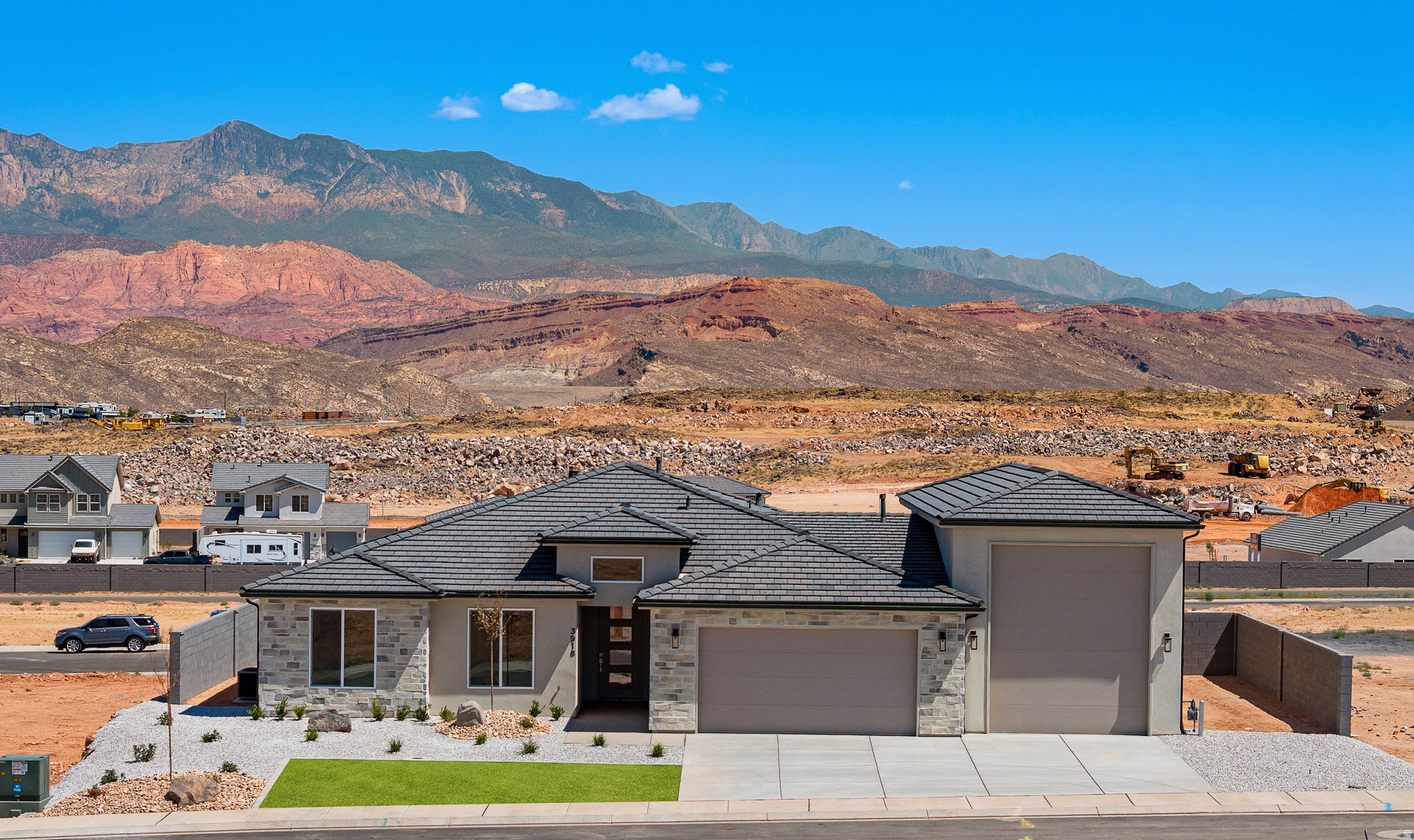 Views of Pine Valley Mountain will stop you in your tracks the second you walk through the front door of this brand new home in Red Slate Estates, moments from Sand Hollow Reservoir. Built with 2x6 exterior walls and a 50ft deep RV/Boat garage with 220 power, this home is as functional as it is beautiful. The open great room, kitchen, and dining area are entirely carpet-free, showcasing a fireplace with built-ins and a large pantry. The primary suite impresses with box trey ceilings, double vanities, soaker tub, tiled walk-in shower, and a spacious walk-in closet. Bedrooms include ceiling fans and canned lighting, and the laundry room offers a sink with cabinetry. Take in those unobstructed Pine Valley Mountain views from your covered patio.