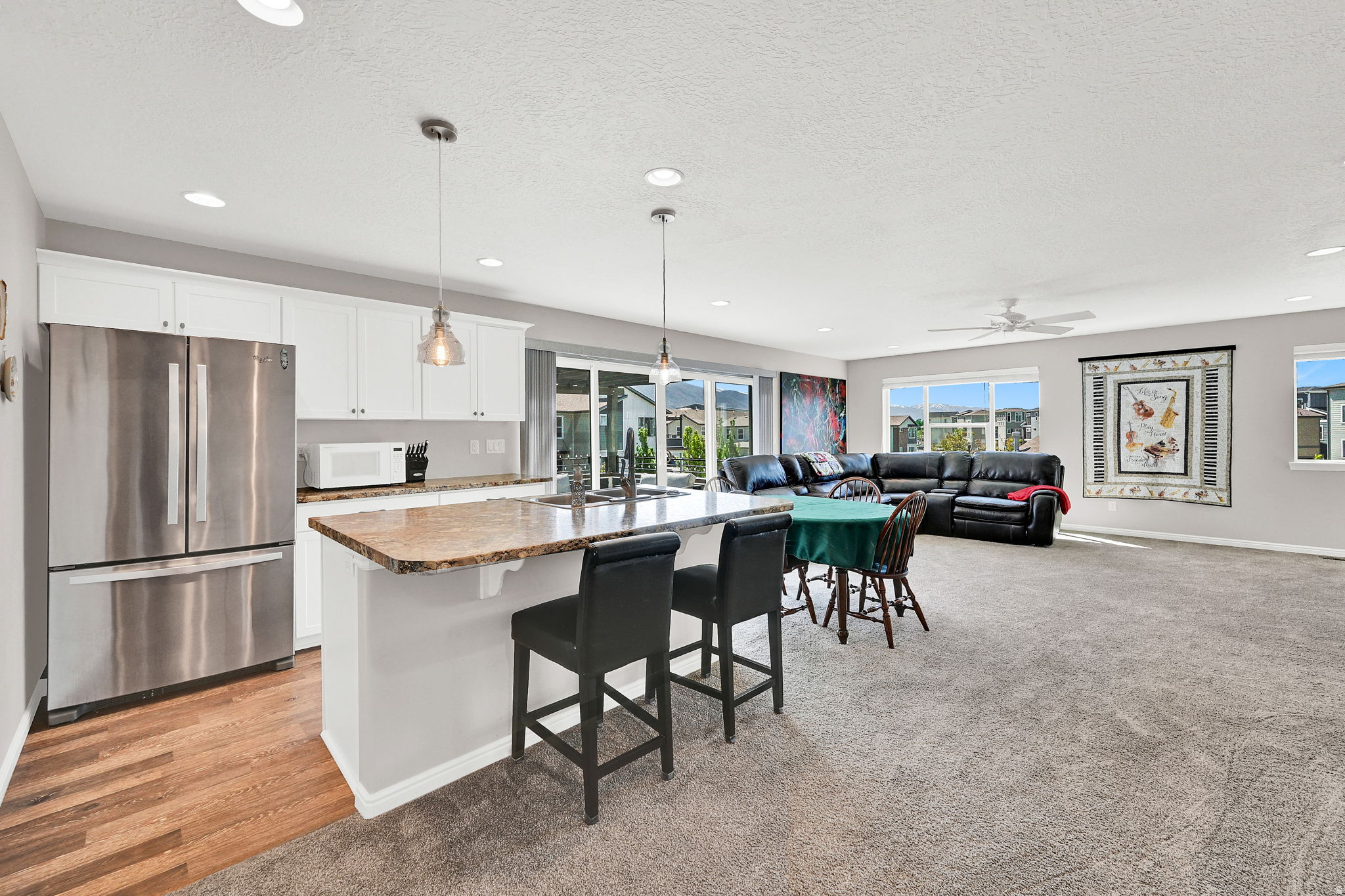 ***BACK ON THE MARKET DUE TO BUYER LOST HIS JOB & PRICE IMPROVEMENT***MAKE SURE YOU USE THE TOUR TAB*** and check out this beautiful home.  Location, comfort, and stress-free living! This coveted two-story townhouse end unit in Avenues at the Station is the 2366 sq. ft. Uniquely designed with the Primary Suite on the main floor, along with the main kitchen, large living room, and a half bath. The upper floor opens to an expansive great room including a "party kitchen" and a 13'x12' deck for relaxation and entertaining! Two additional large bedrooms, with a full bath, and laundry, complete the space. There is an Option to add a laundry hookup on the main floor for anyone who has one level living desires.  This home has the best lot in the subdivision, nestled near the guest parking lot and community pool. There is a greater distance from all the other homes, which offers extra privacy and stunning mountain views year-round. Just step out your door, the options are endless! Take a walk or cycle on the Denver and Rio Grande Western (D&RGW) Rail Trail, part of a 100-mile connecting trail system extending from Ogden to Provo! Or, enjoy Station Park's shopping, theater, and restaurants, University Health Center, and the Frontrunner. Less than 1 mile from Lagoon amusement park  you can walk or take a free shuttle available at Station Park. Your large private entry porch is plumbed with a gas line for your grill, and plenty of space for a picnic and BBQ. The Primary suite on the main floor has custom plantation shutters and its own private access to the front porch. The ensuite bathroom has a spacious walk-in closet and includes a GFI plug next to the toilet for a bidet seat. The main floor has engineered hardwood flooring and 9-foot ceilings. The large second-floor east-facing deck is shady in summer and, combined with the great room, creates an expanded entertainment space for your family and friends. New ceiling fans [2022], New paint [2024], New appliances [2025], Custom blinds throughout the home, Soft close cabinetry in the main kitchen and primary suite, Garage has epoxy floor coating, extra bright lighting, and ceiling-mounted storage shelves.  THIS IS A MUST SEE AT THIS UPDATED PRICE!