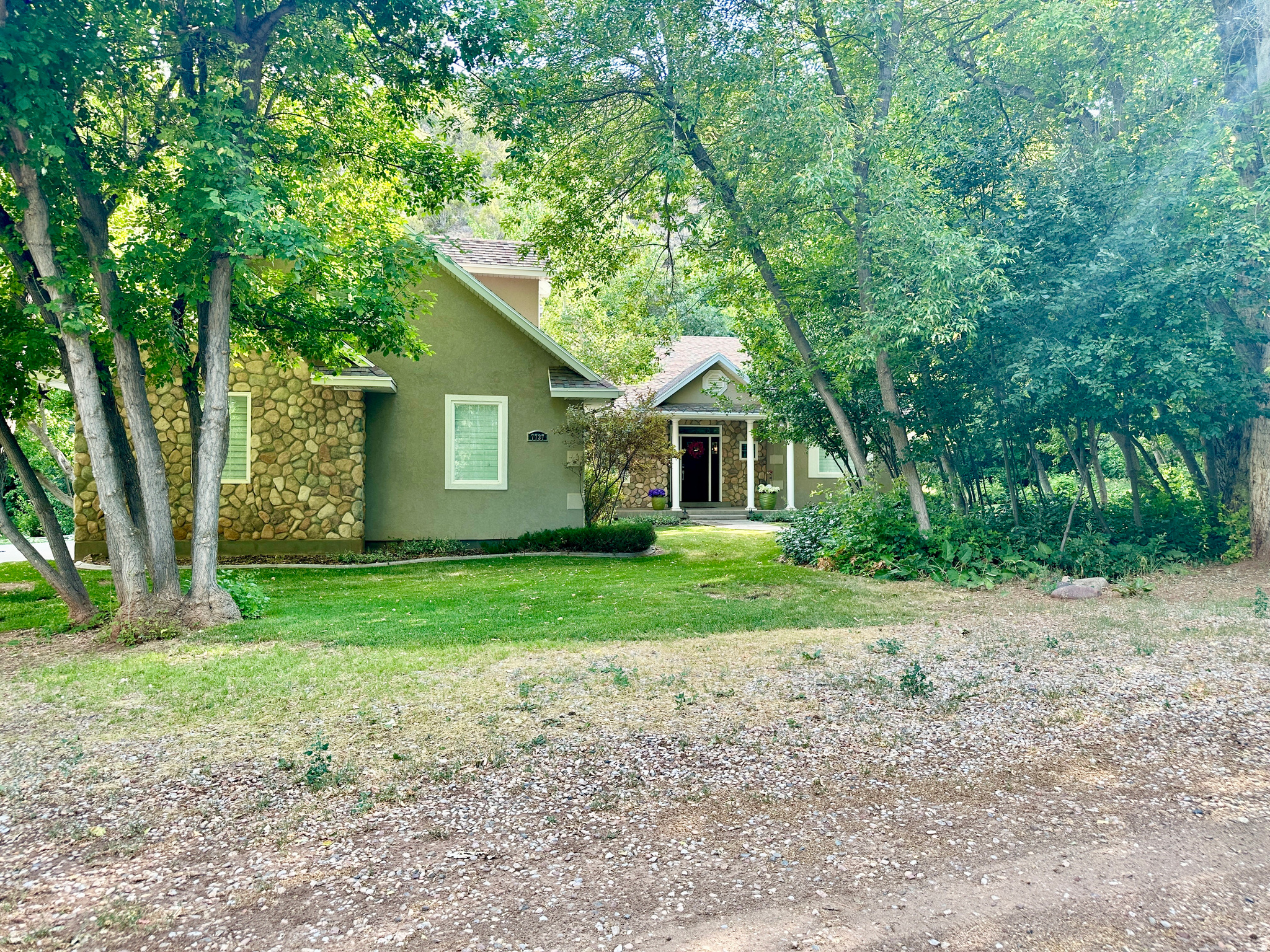 Nestled in beautiful Dry Fork Canyon, this stunning property offers the perfect blend of comfort, functionality, and peaceful mountain living. The main home features 4 bedrooms and 2 bathrooms. One of the bedrooms has a built-in workspace and could easily serve as a dedicated office. The open-concept kitchen showcases granite countertops, tile and carpet flooring throughout, and in-floor electric radiant heating for added comfort.  Surrounded by mature trees with a stream running through the property, this home provides a truly serene setting. The property is equipped with three 1,000-gallon propane tanks and a propane backup generator for peace of mind during power outages. Beautifully maintained landscaping and an automatic sprinkler system enhance the outdoor space.  Storage and garage space are unmatched, featuring a 2-car attached garage, a 2-car detached garage, a separate 1-car detached garage, and an impressive 30' x 40' two-space RV garage complete with an 8-foot-wide cold storage room and rear workspace. RV garage doors measure 12 feet wide by 13.5 feet tall, and power is connected to all garages.  Also included is a charming 1-bedroom, 1-bath cabin with its own private balcony - perfect for guests, rental income, or a peaceful retreat.  Peace, privacy, and natural beauty abound on this exceptional canyon property.