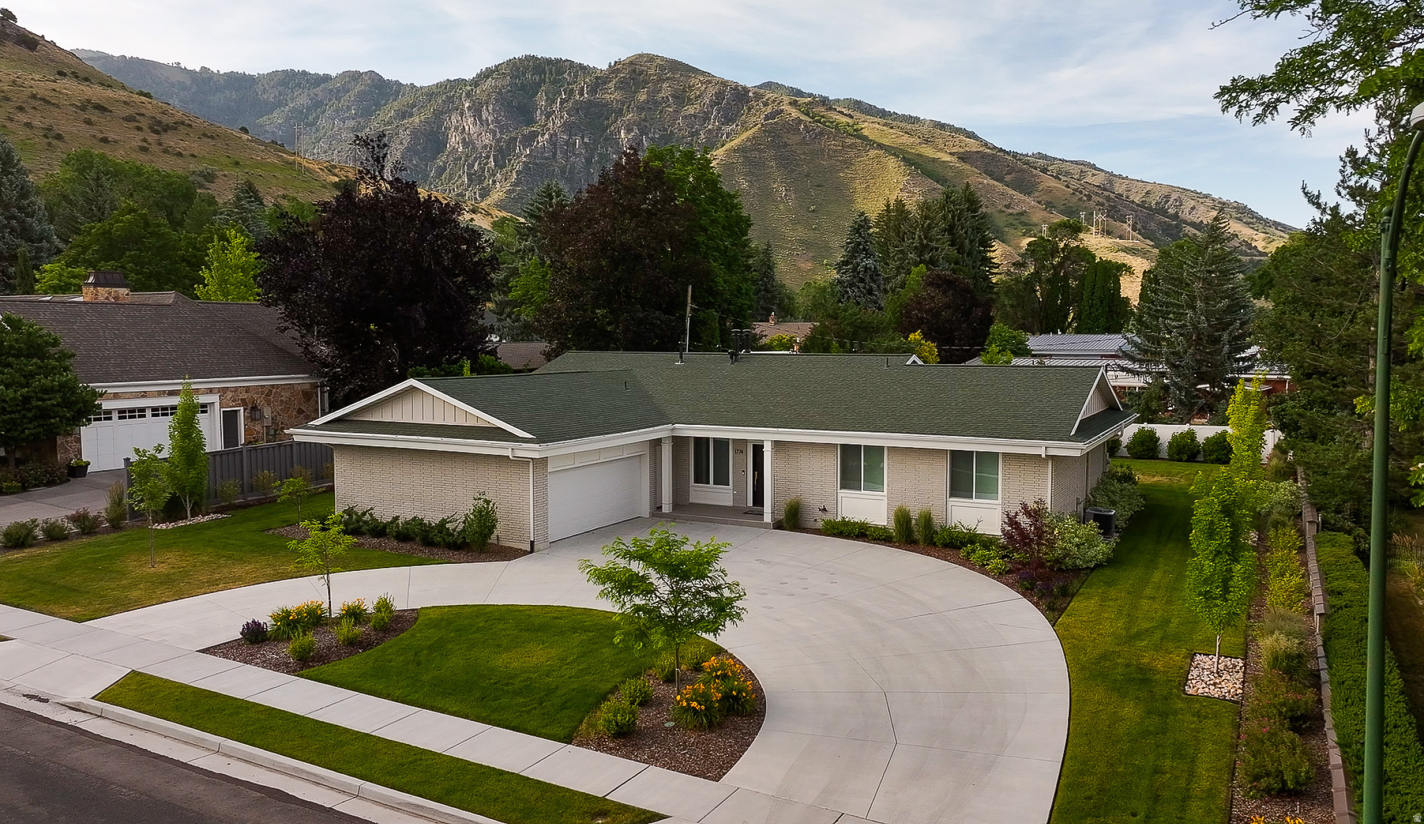 Don't miss your opportunity to own this stunning, fully renovated home in the highly desirable Lundstrom Park neighborhood on Logan's east bench! Located just one block from the Logan Golf & Country Club and minutes from Utah State University, this home offers an unbeatable combination of luxury, location, and quality. Inside, you'll immediately notice the thoughtful design and exceptional craftsmanship, featuring custom walnut stair railings, beautiful fireplace mantels, exposed beams, and handcrafted bathroom vanities. The expanded gourmet kitchen is the heart of the home, complete with elegant quartz countertops, floor-to-ceiling custom cabinetry with soft-close doors and drawers, crown molding, and premium stainless steel appliances, including a double oven, induction cooktop, and drawer microwave. No detail was overlooked in this top-to-bottom renovation. Major upgrades include a brand-new main sewer line, main water line, plumbing, electrical, and HVAC systems, providing peace of mind for years to come. Step outside to enjoy the beautifully landscaped yard with new sprinklers, mature trees, flower beds, fresh sod, a circular driveway, and new sidewalks. Relax under the covered back patio while taking in breathtaking mountain views and entertaining family and friends. This remarkable home offers countless upgrades that must be seen to be fully appreciated. Browse the photos, schedule your private showing, and experience it for yourself!