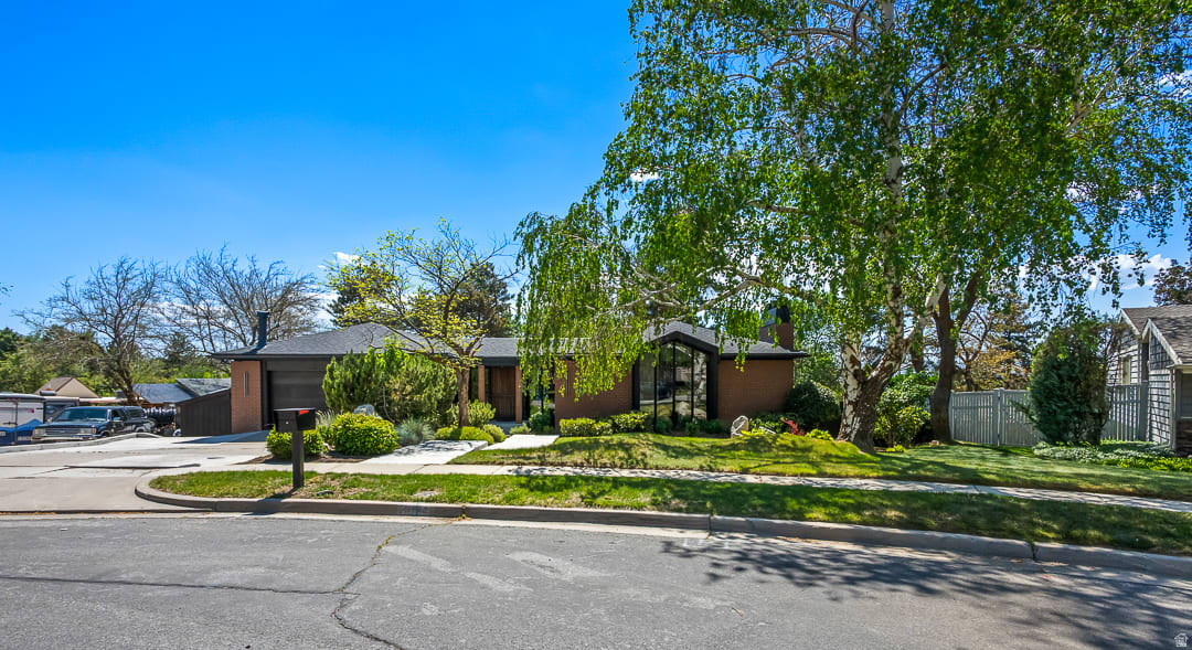 Designed and built as the personal residence of acclaimed Utah architect Ron Molen, this extraordinary mid-century modern estate represents a rare convergence of architectural pedigree, timeless design, and thoughtful restoration. Positioned on one of the premier lots in Sherwood Hills, the home sits privately on over a third of an acre, where mature landscaping, terraced grounds, and sweeping valley and mountain views create a setting that feels both secluded and deeply connected to its surroundings.  Molen was known for creating homes that balanced openness with warmth-spaces designed not simply to impress, but to elevate everyday living. This residence embodies that philosophy at every turn. Signature architectural elements remain beautifully intact, including the iconic conversation pit, rough-sawn wood detailing, soaring vaulted ceilings, expansive walls of glass, and the striking aggregate flooring that flows seamlessly from the interior living spaces to the outdoor entertaining areas. The result is a home that blurs the line between indoors and out in true mid-century modern fashion.  Over the past year, the home has undergone an extensive, carefully curated renovation focused on honoring the integrity of Molen's original design while introducing the level of refinement expected in a modern luxury residence. Every update was approached with intention-preserving original character wherever possible while incorporating exceptional craftsmanship, designer fixtures, and premium appliances throughout. The balance achieved here is remarkably rare: authentic mid-century soul paired with elevated contemporary livability.  The kitchen and baths have been thoughtfully reimagined with high-end finishes and timeless materials that complement the home's architectural language rather than compete with it. Every detail-from lighting selections to custom millwork and hardware-was chosen to feel cohesive with the original 1968 vision. Unlike many remodeled mid-century homes that lose their identity through over-modernization, this residence remains unmistakably Molen.  Perfectly positioned at the base of Big and Little Cottonwood Canyons, the home offers exceptional access to some of Utah's most celebrated outdoor recreation. World-class skiing at Alta, Snowbird, Brighton, and Solitude is just minutes away, while countless hiking and biking trails, climbing routes, reservoirs, and alpine escapes are practically at your doorstep. Despite its close proximity to the mountains, the property remains conveniently connected to the city, offering a rare balance of adventure, privacy, and everyday accessibility.  The outdoor environment is equally compelling. The heated pool, covered patio spaces, mature trees, fruit trees, and private terraced yard create a resort-like atmosphere designed for both intimate evenings and large-scale entertaining. Molen believed landscapes were an extension of architecture itself, and that philosophy is fully realized here. The expansive backyard becomes an extension of the living space, framed by clean architectural lines and anchored by exceptional privacy.  With nearly 5,000 square feet, six bedrooms, flexible lower-level living with a second kitchen and separate entrance, and true single-level living potential on the main floor, the home offers remarkable versatility without sacrificing design integrity.  Architecturally significant homes of this caliber rarely become available-especially those designed by the architect for his own use and restored with such respect for their original intent. This is more than a home; it is a piece of Utah architectural history, meticulously preserved and beautifully evolved for modern living.