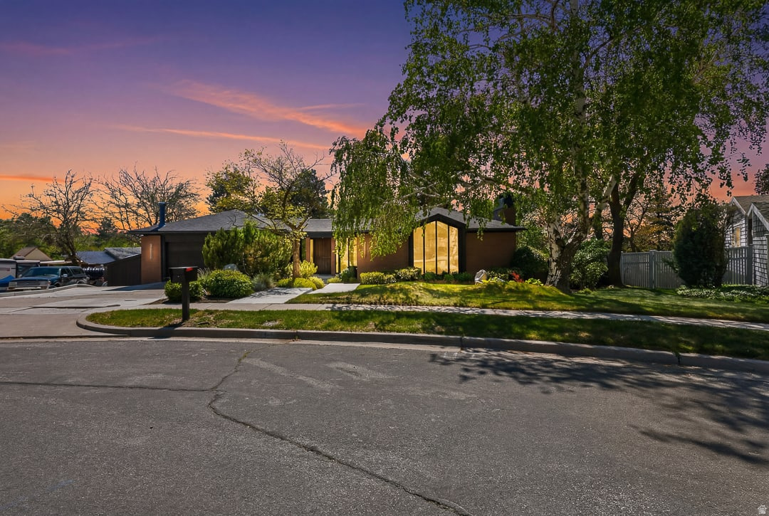 **HUGE PRICE IMPROVEMENT** Designed and built as the personal residence of acclaimed Utah architect Ron Molen, this extraordinary mid-century modern estate represents a rare convergence of architectural pedigree, timeless design, and thoughtful restoration. Positioned on one of the premier lots in Sherwood Hills, the home sits privately on over a third of an acre, where mature landscaping, terraced grounds, and sweeping valley and mountain views create a setting that feels both secluded and deeply connected to its surroundings.  Molen was known for creating homes that balanced openness with warmth-spaces designed not simply to impress, but to elevate everyday living. This residence embodies that philosophy at every turn. Signature architectural elements remain beautifully intact, including the iconic conversation pit, rough-sawn wood detailing, soaring vaulted ceilings, expansive walls of glass, and the striking aggregate flooring that flows seamlessly from the interior living spaces to the outdoor entertaining areas. The result is a home that blurs the line between indoors and out in true mid-century modern fashion.  Over the past year, the home has undergone an extensive, carefully curated renovation focused on honoring the integrity of Molen's original design while introducing the level of refinement expected in a modern luxury residence. Every update was approached with intention-preserving original character wherever possible while incorporating exceptional craftsmanship, designer fixtures, and premium appliances throughout. The balance achieved here is remarkably rare: authentic mid-century soul paired with elevated contemporary livability.  The kitchen and baths have been thoughtfully reimagined with high-end finishes and timeless materials that complement the home's architectural language rather than compete with it. Every detail-from lighting selections to custom millwork and hardware-was chosen to feel cohesive with the original 1968 vision. Unlike many remodeled mid-century homes that lose their identity through over-modernization, this residence remains unmistakably Molen.  Perfectly positioned at the base of Big and Little Cottonwood Canyons, the home offers exceptional access to some of Utah's most celebrated outdoor recreation. World-class skiing at Alta, Snowbird, Brighton, and Solitude is just minutes away, while countless hiking and biking trails, climbing routes, reservoirs, and alpine escapes are practically at your doorstep. Despite its close proximity to the mountains, the property remains conveniently connected to the city, offering a rare balance of adventure, privacy, and everyday accessibility.  The outdoor environment is equally compelling. The heated pool, covered patio spaces, mature trees, fruit trees, and private terraced yard create a resort-like atmosphere designed for both intimate evenings and large-scale entertaining. Molen believed landscapes were an extension of architecture itself, and that philosophy is fully realized here. The expansive backyard becomes an extension of the living space, framed by clean architectural lines and anchored by exceptional privacy.  With nearly 5,000 square feet, six bedrooms, flexible lower-level living with a second kitchen and separate entrance, and true single-level living potential on the main floor, the home offers remarkable versatility without sacrificing design integrity.  Architecturally significant homes of this caliber rarely become available-especially those designed by the architect for his own use and restored with such respect for their original intent. This is more than a home; it is a piece of Utah architectural history, meticulously preserved and beautifully evolved for modern living.