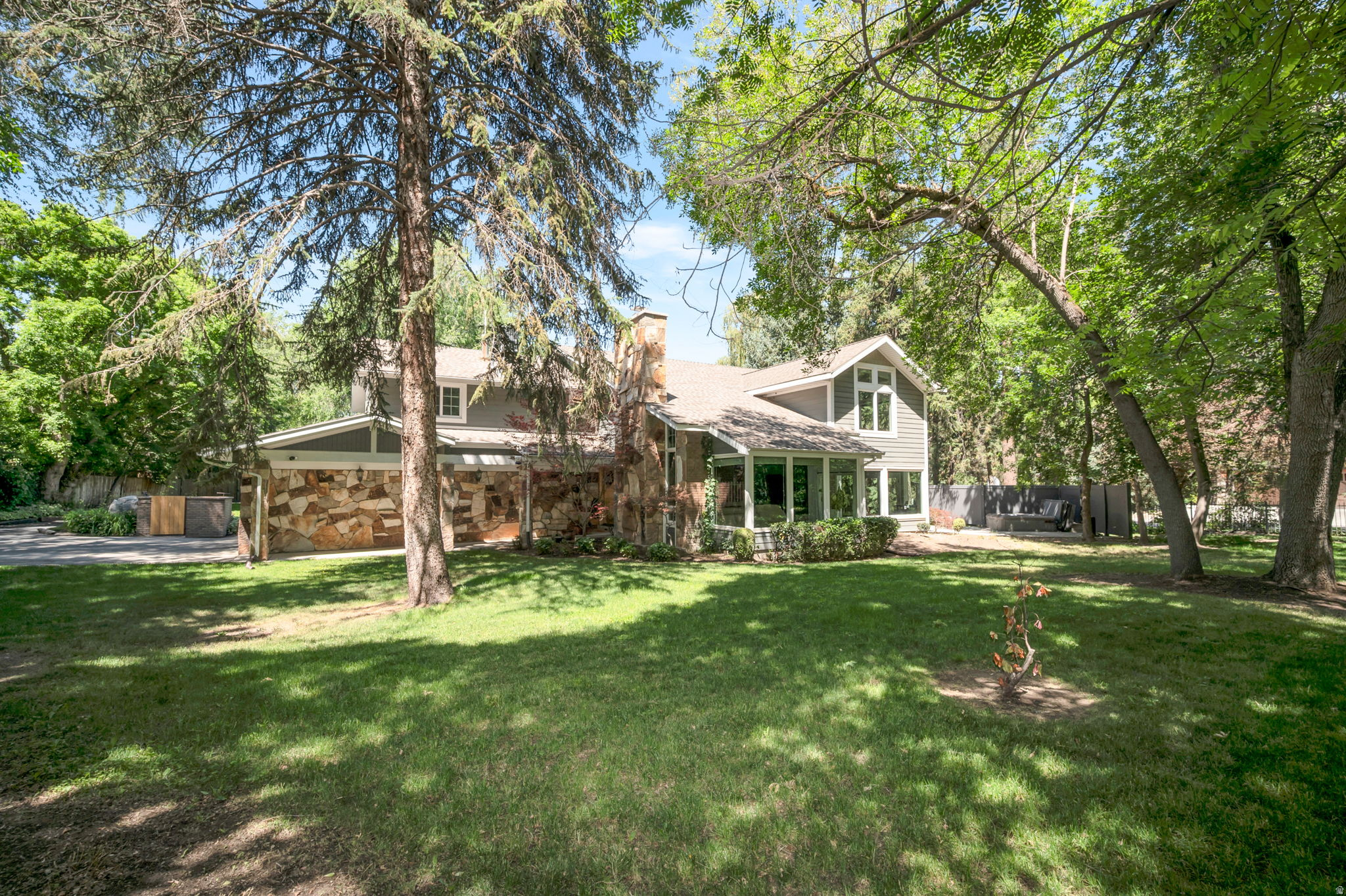 Tucked away on a quiet Holladay cul-de-sac, this stunning 4-bedroom home sits on nearly an acre of towering trees, manicured lawn, and a sparkling swimming pool - a true private retreat. Inside, a dramatic two-story entry, stone fireplace, and a beautifully updated chef's kitchen and granite island make everyday living feel special. With an additional 2 car garage, sports court, covered patio, and a luxurious primary suite, this property has room for every part of your life. $50k price improvement!